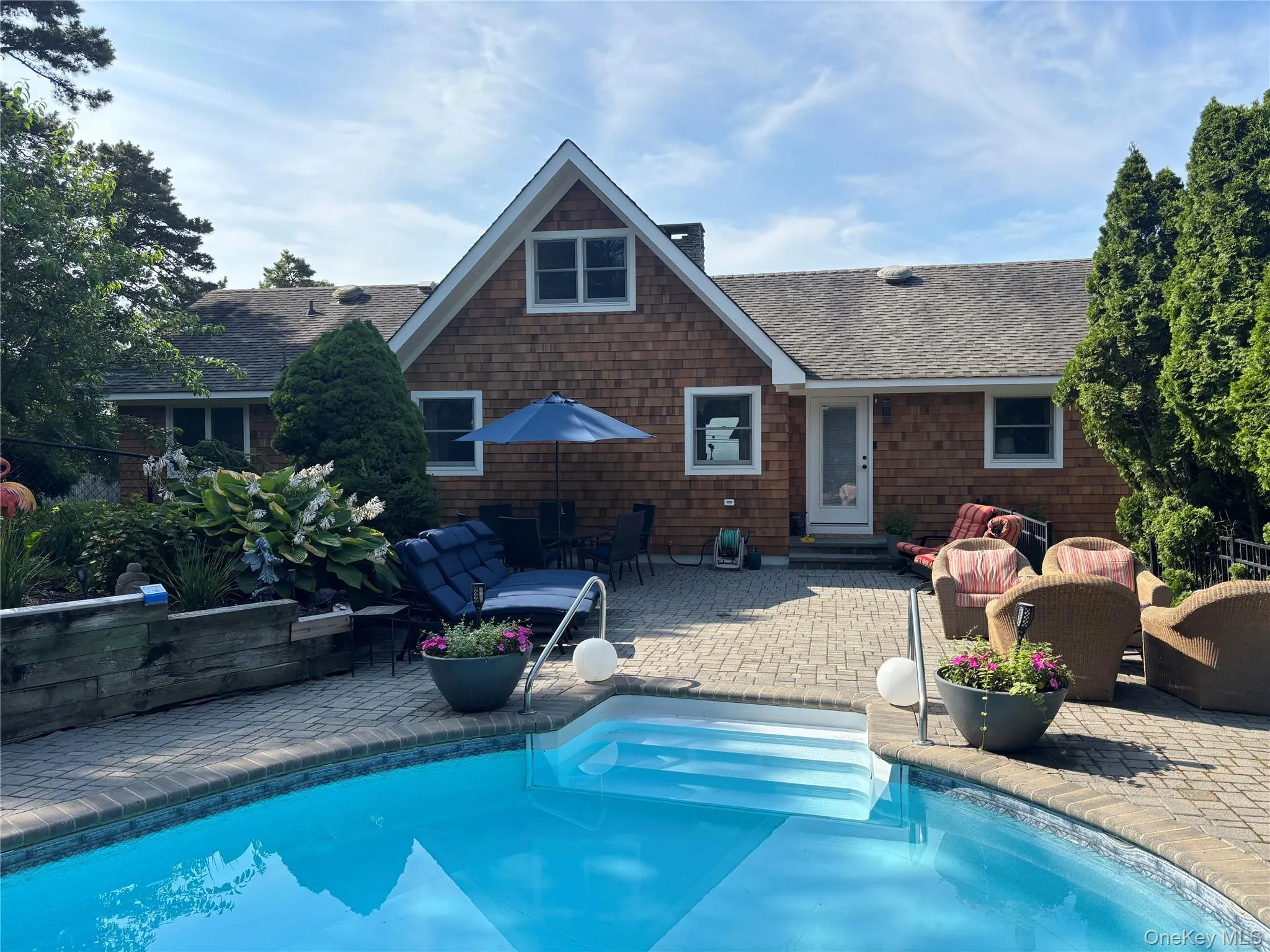 Outdoor pool featuring a patio, an outdoor living space, and entry steps Outdoor pool featuring a patio, an outdoor living space, and entry steps