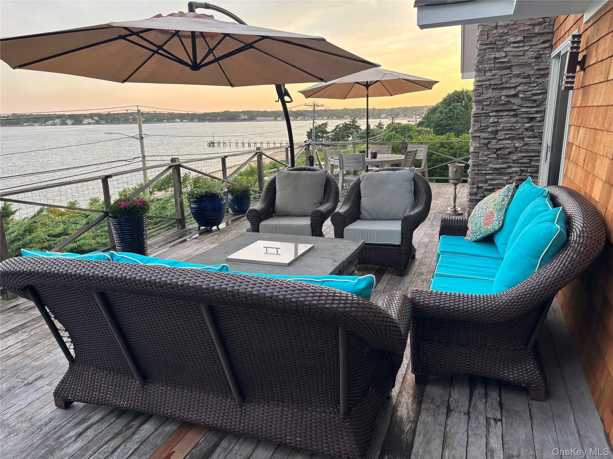 Wooden deck featuring an outdoor living space and a water view Wooden deck featuring an outdoor living space and a water view