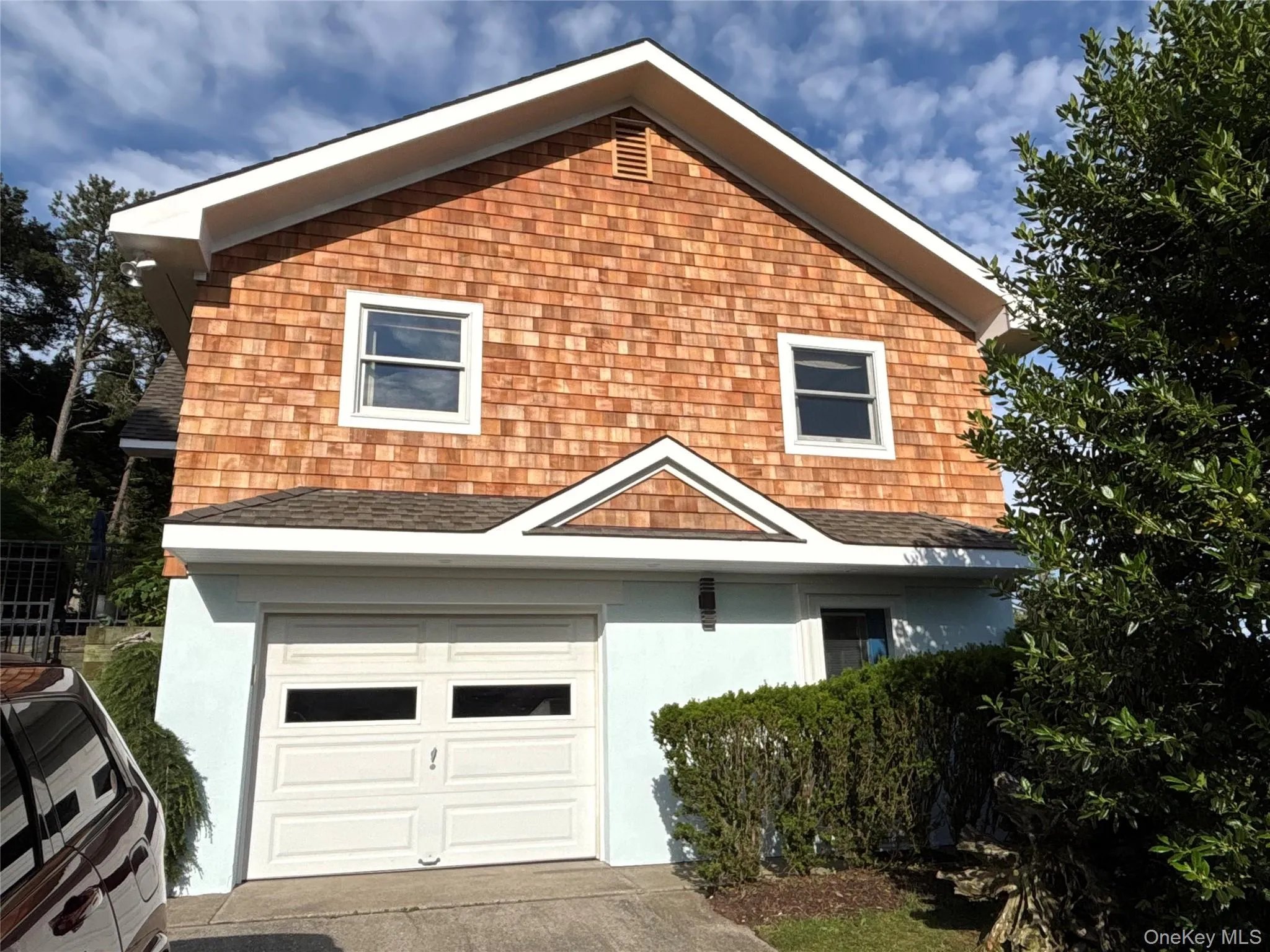 View of front of property with an attached garage, stucco siding, driveway, and a shingled roof View of front of property with an attached garage, stucco siding, driveway, and a shingled roof