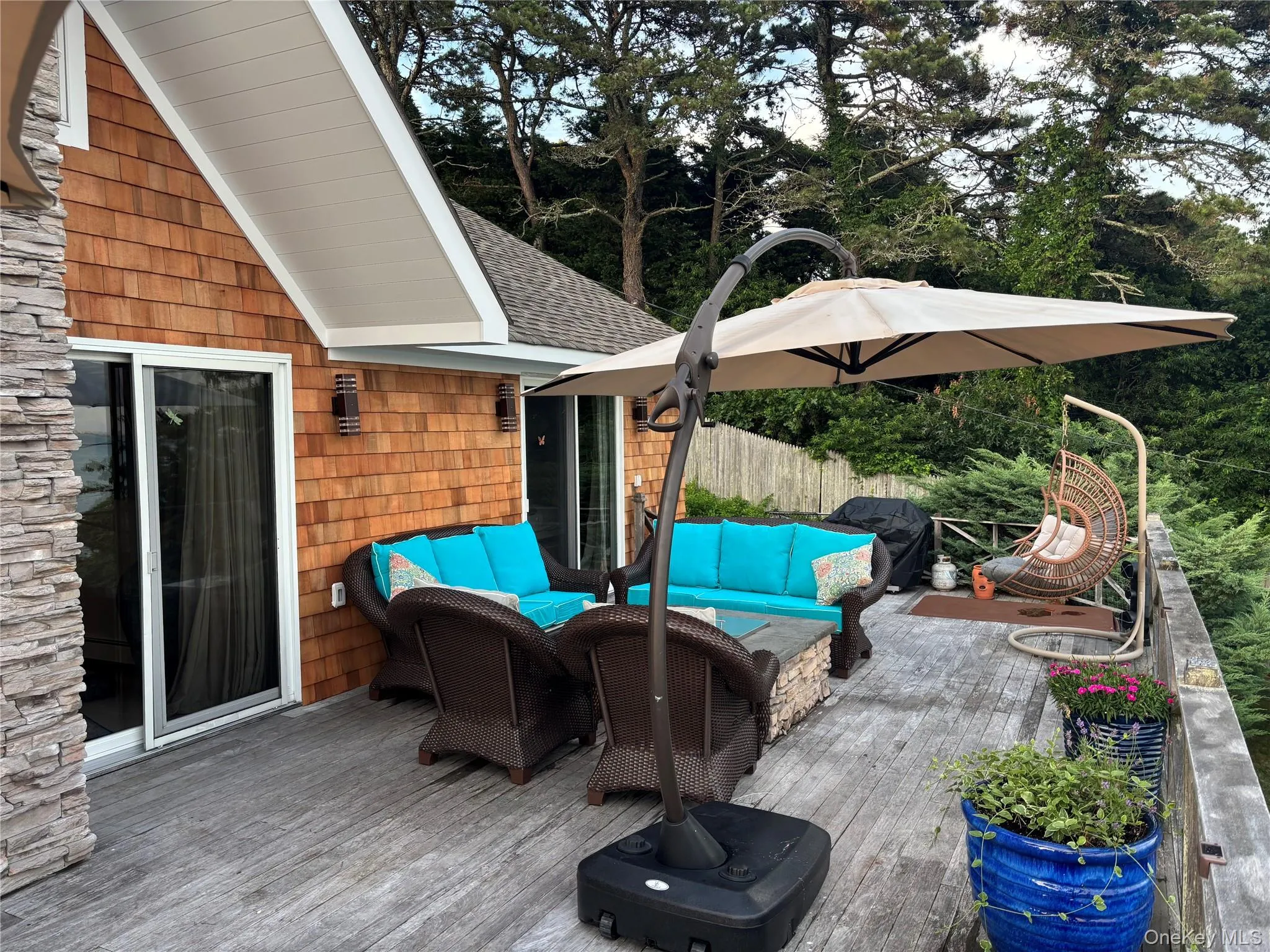 Deck with an outdoor living space, area for grilling, and view of scattered trees Deck with an outdoor living space, area for grilling, and view of scattered trees