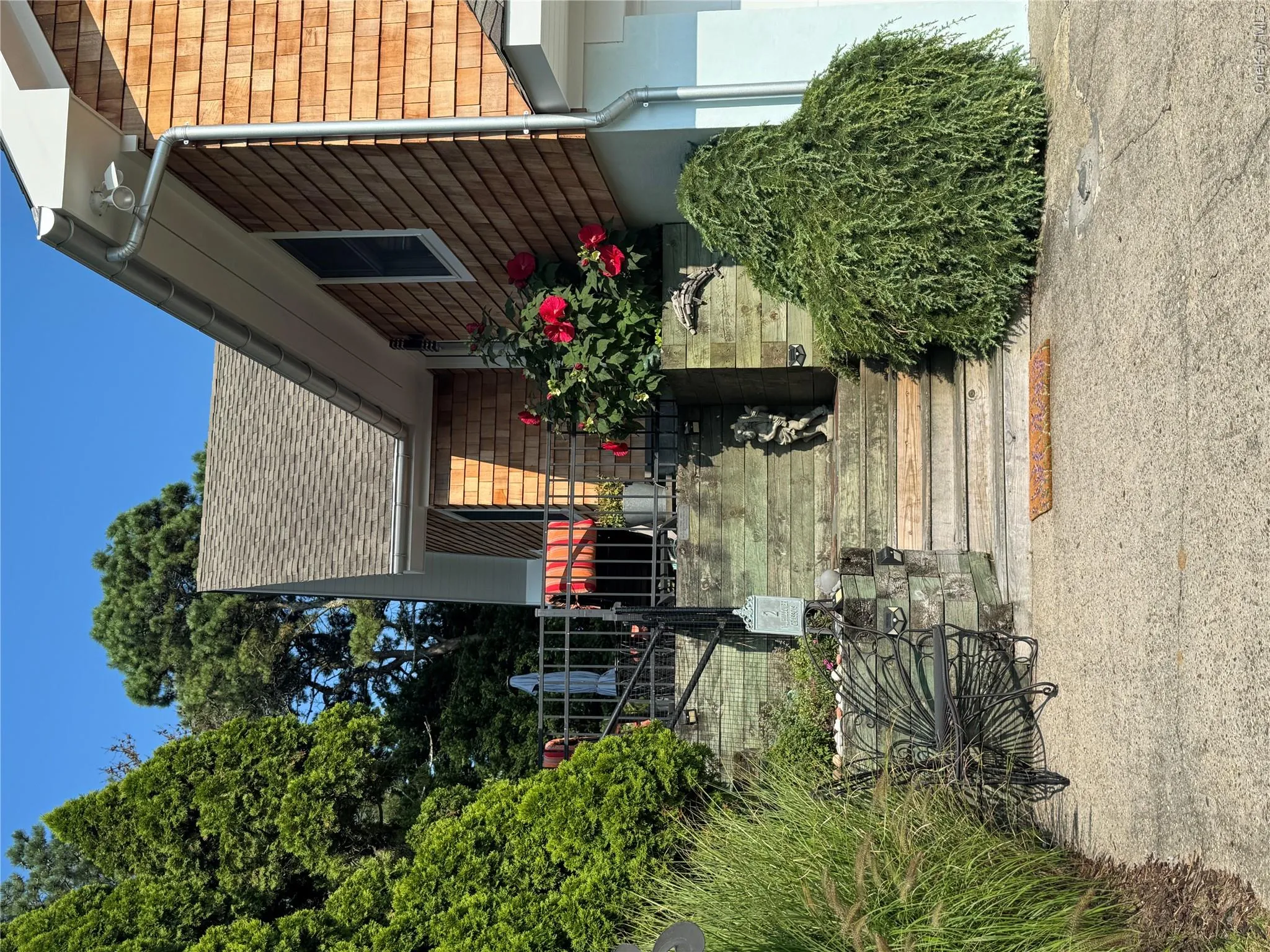 View of exterior entry featuring a shingled roof View of exterior entry featuring a shingled roof