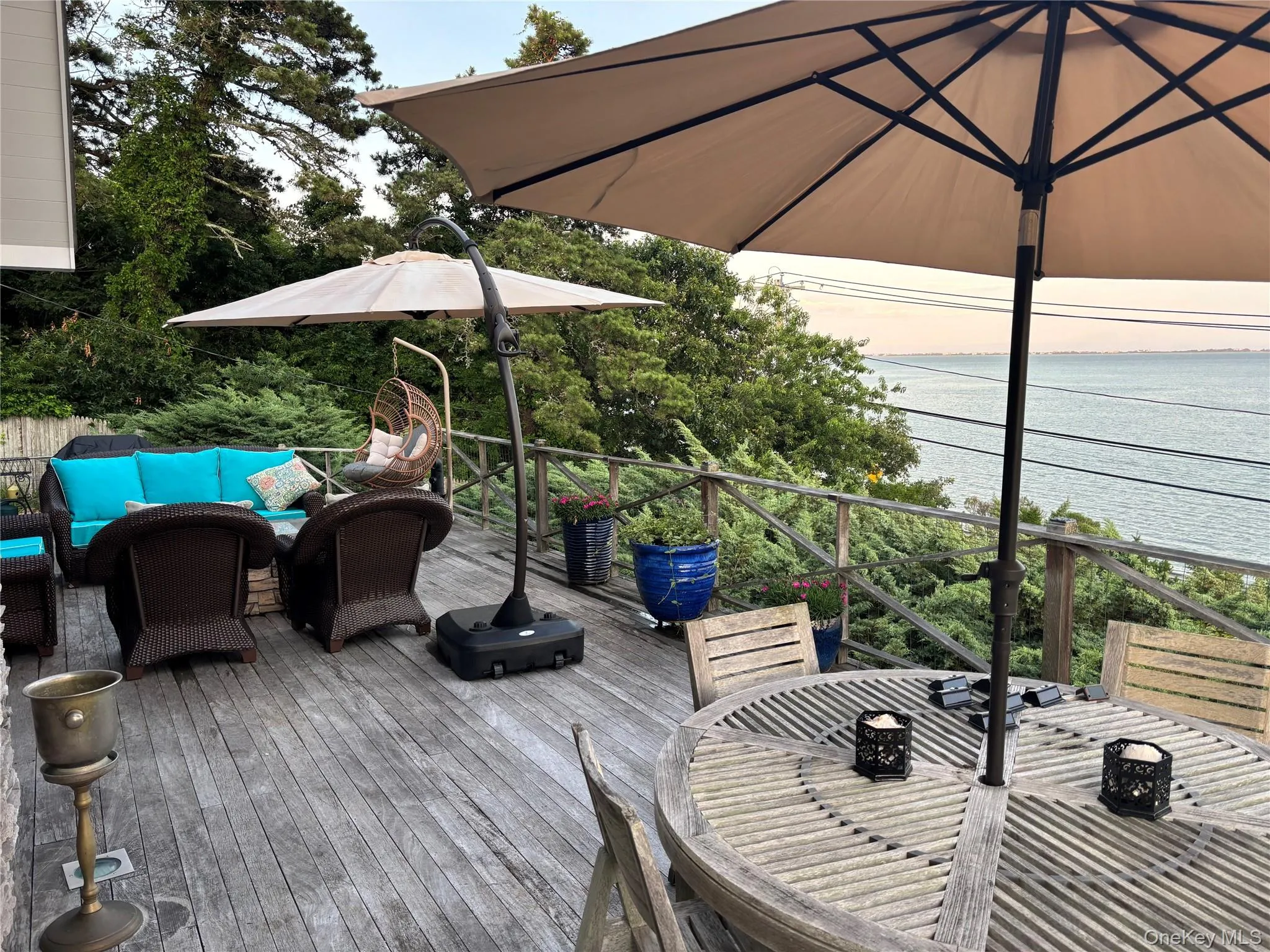 Wooden terrace with a water view, outdoor lounge area, and outdoor dining space Wooden terrace with a water view, outdoor lounge area, and outdoor dining space