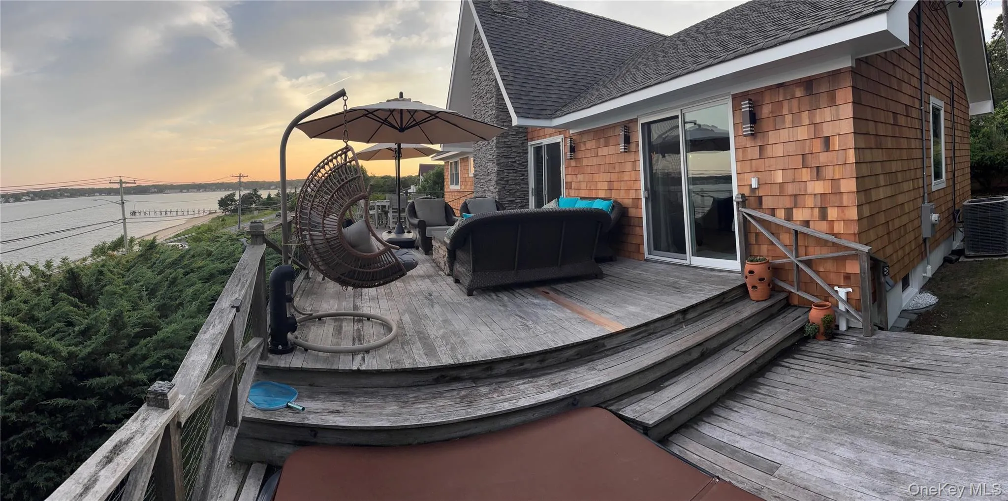 Wooden deck featuring a water view and outdoor lounge area Wooden deck featuring a water view and outdoor lounge area