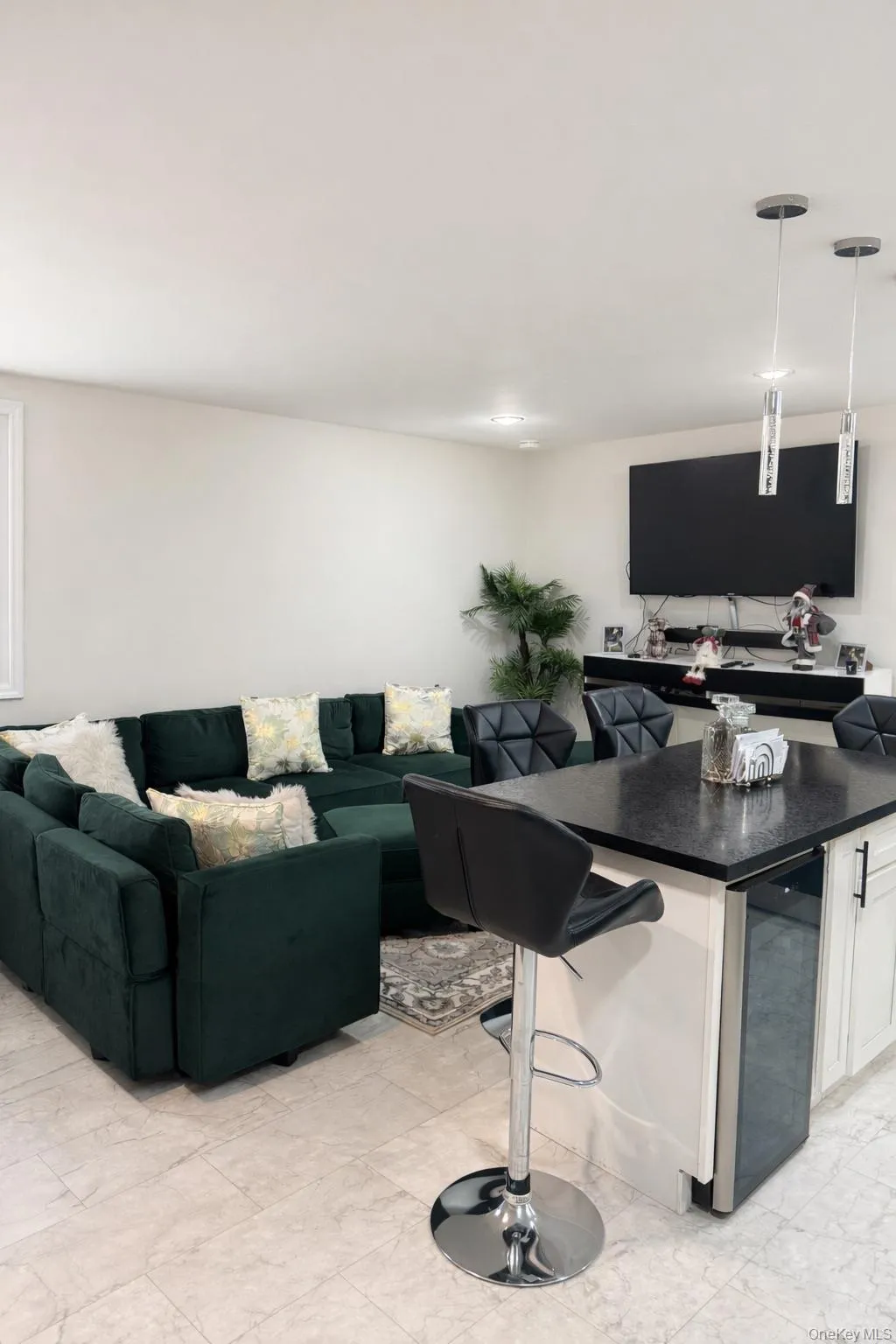 Living room featuring beverage cooler and light marble finish floors Living room featuring beverage cooler and light marble finish floors
