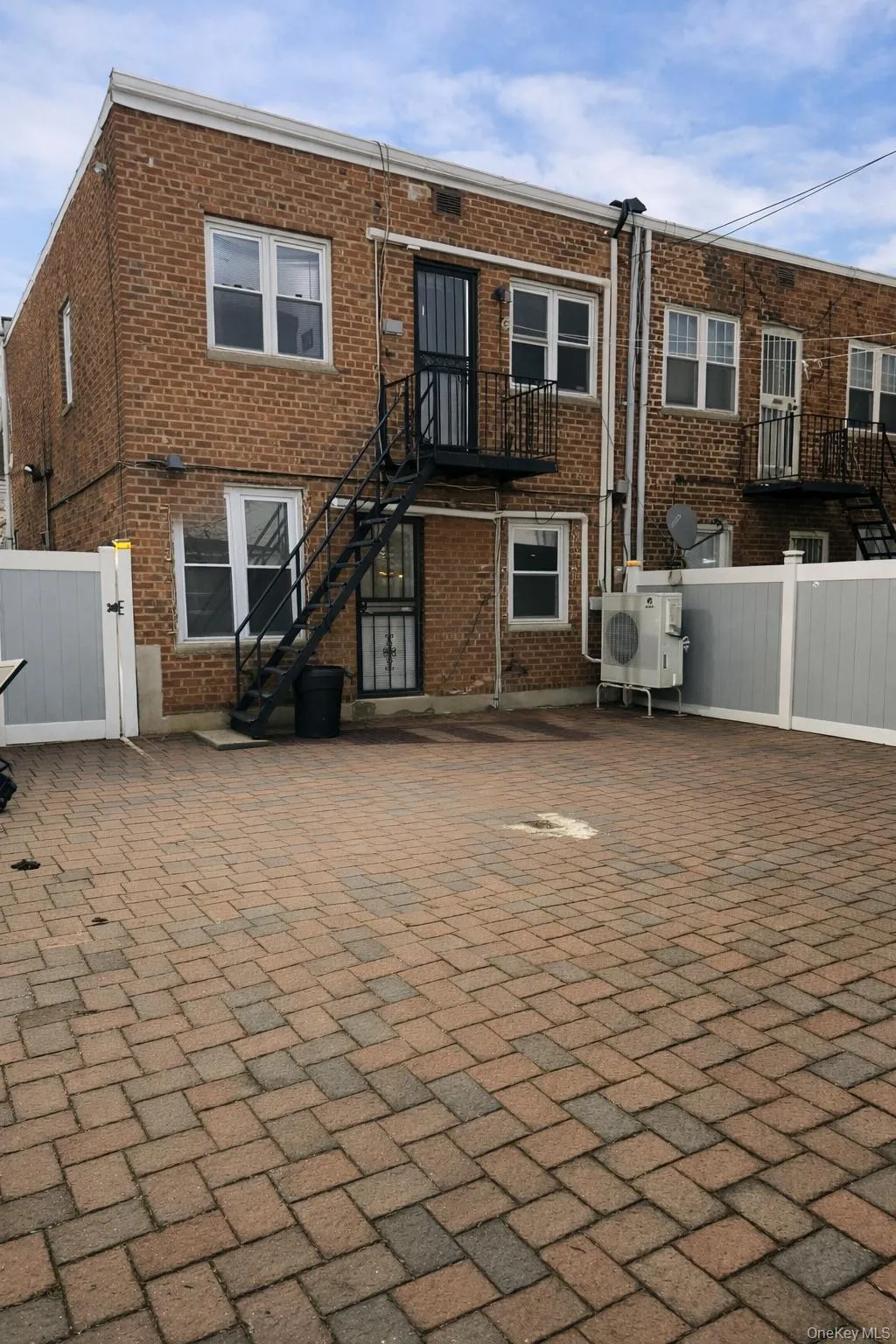 Back of property featuring stairs and brick siding Back of property featuring stairs and brick siding