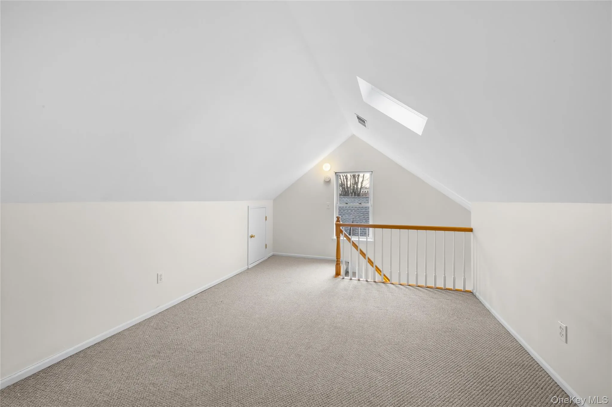 Additional living space featuring a skylight, carpet floors, and lofted ceiling Additional living space featuring a skylight, carpet floors, and lofted ceiling