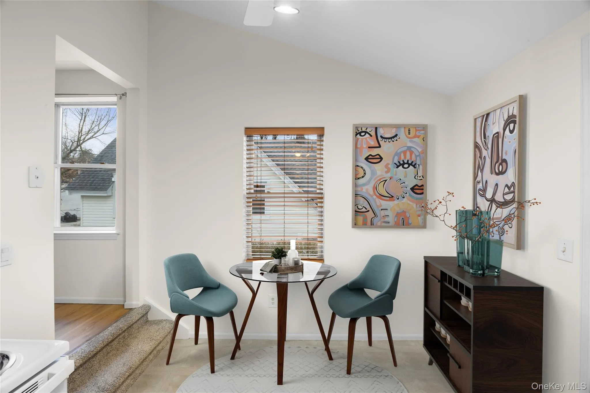 Sitting room featuring lofted ceiling and plenty of natural light/digitally staged Sitting room featuring lofted ceiling and plenty of natural light/digitally staged