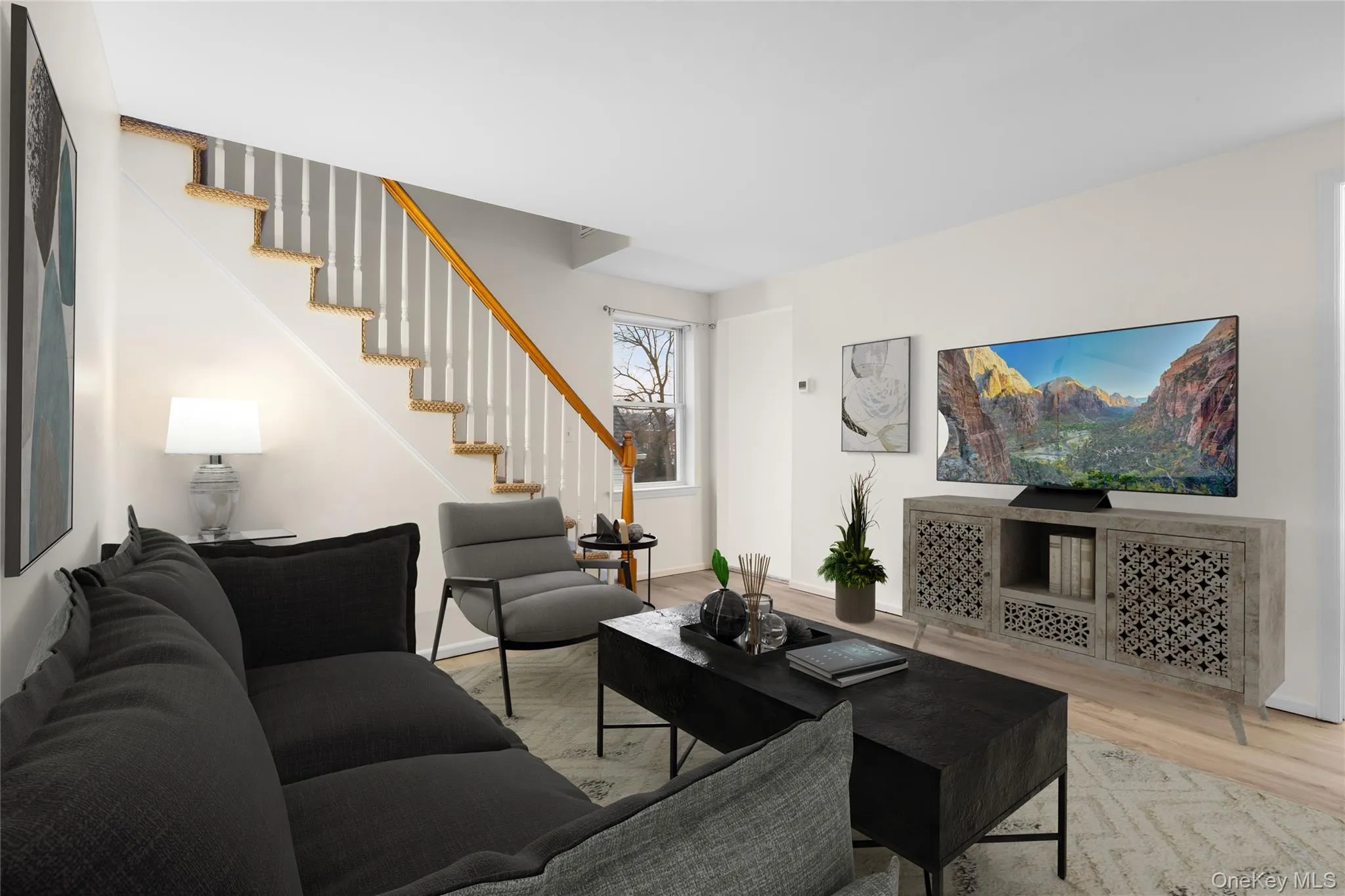 Living room with wood finished floors and stairway/digitally staged Living room with wood finished floors and stairway/digitally staged