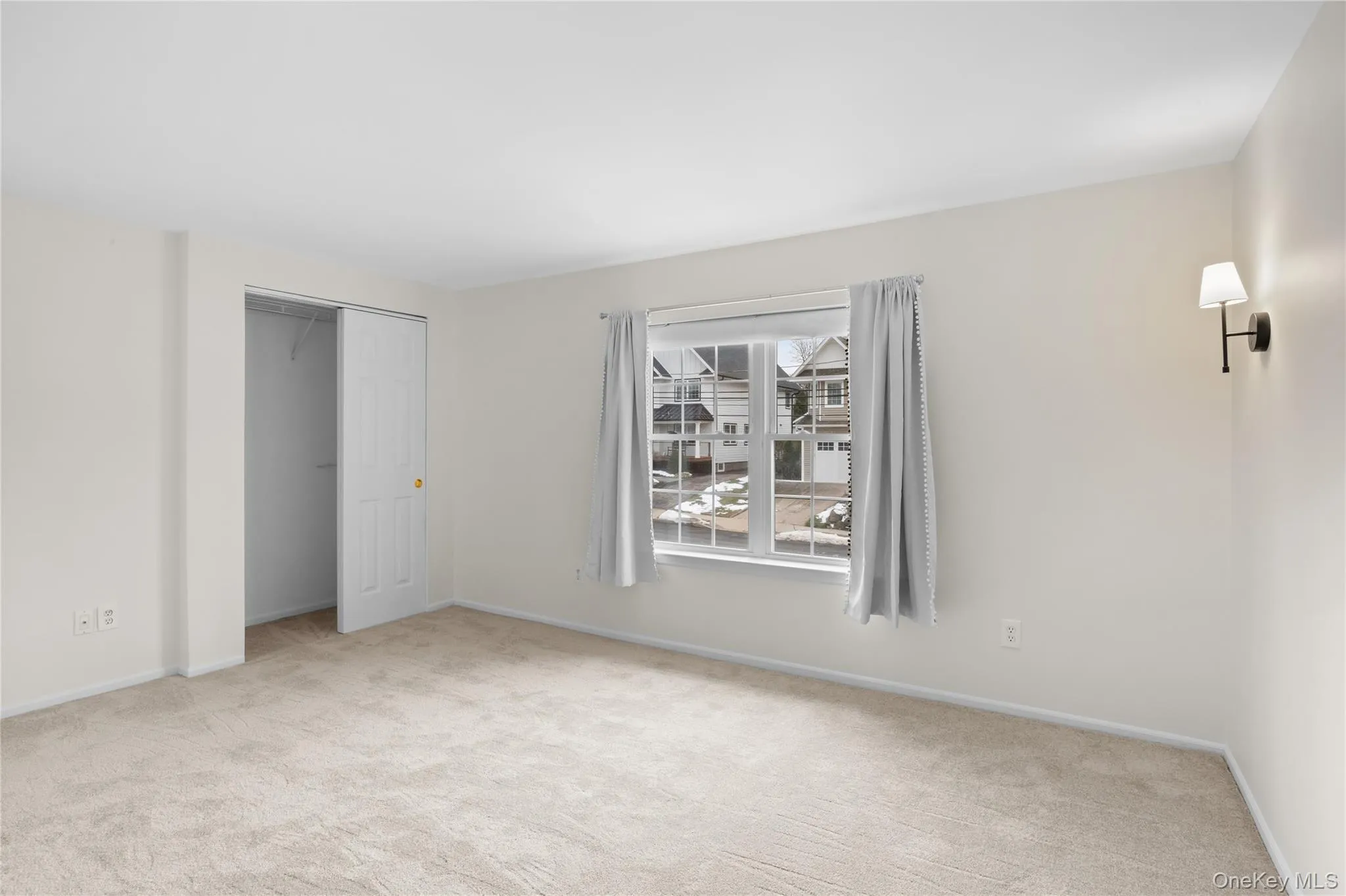 Unfurnished bedroom featuring a closet and light colored carpet Unfurnished bedroom featuring a closet and light colored carpet