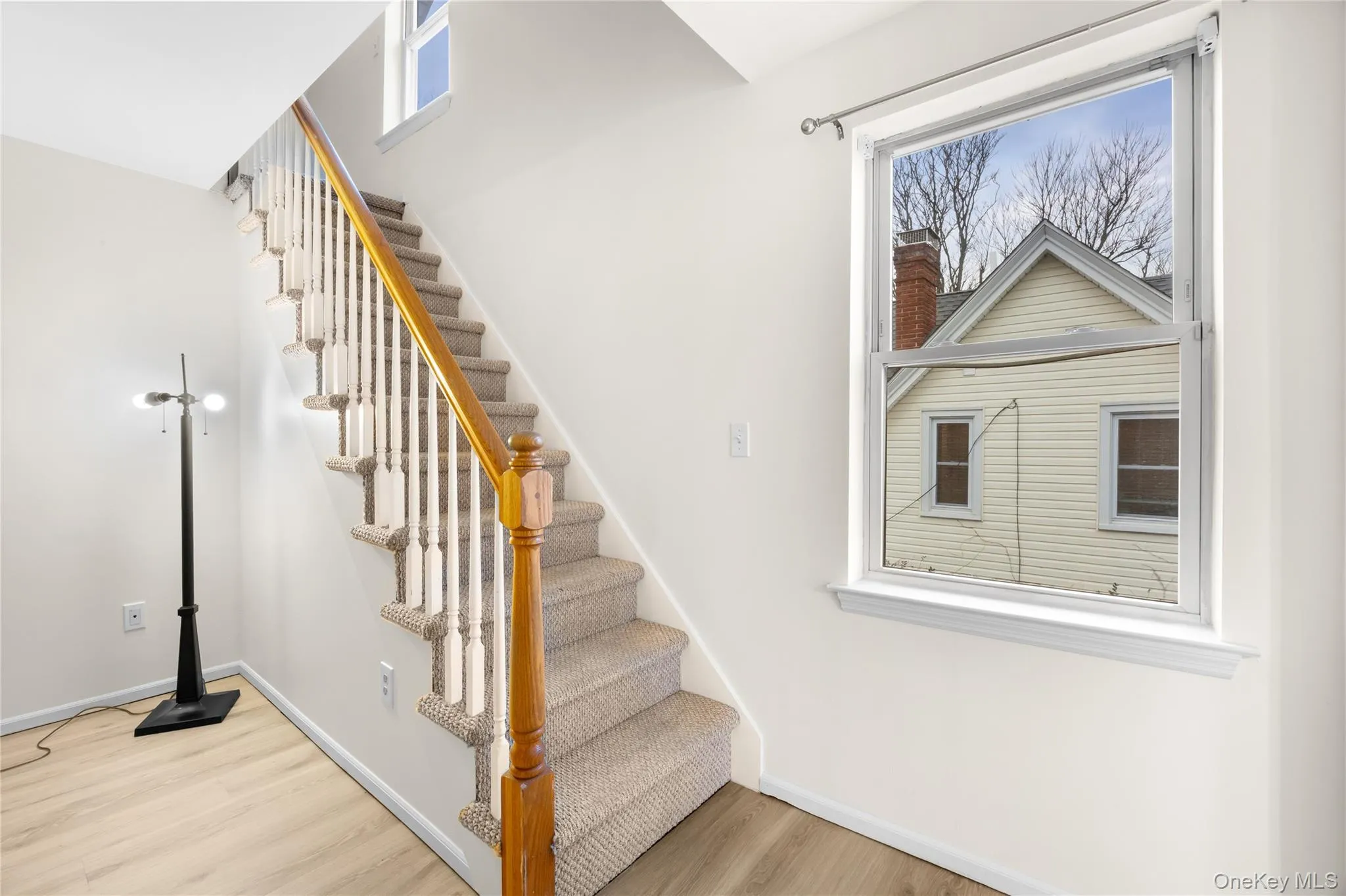 Stairway featuring wood finished floors Stairway featuring wood finished floors