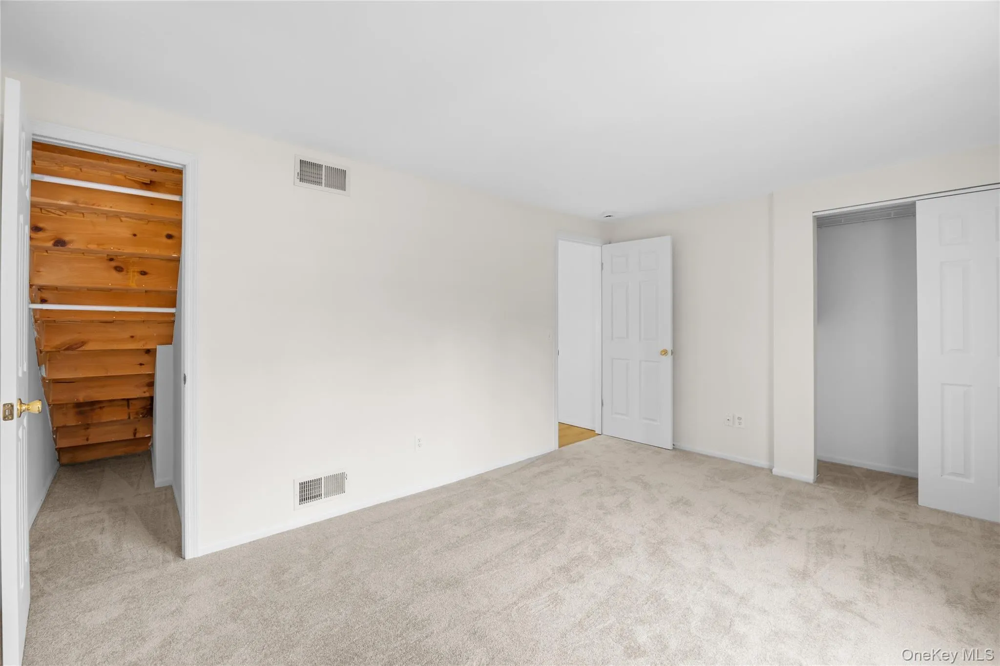 Unfurnished bedroom with light carpet Unfurnished bedroom with light carpet