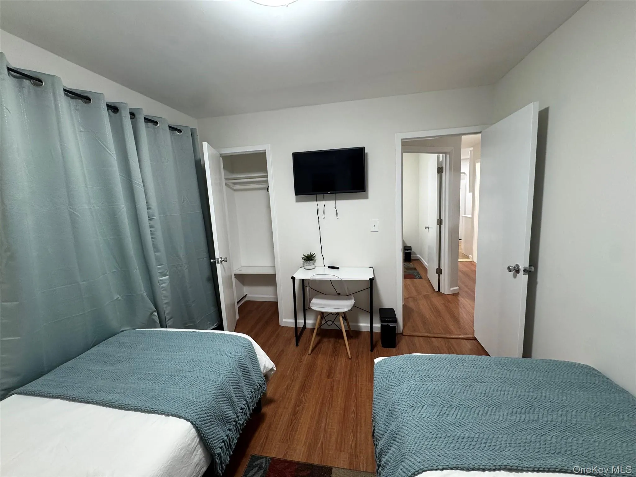 Bedroom featuring wood finished floors Bedroom featuring wood finished floors