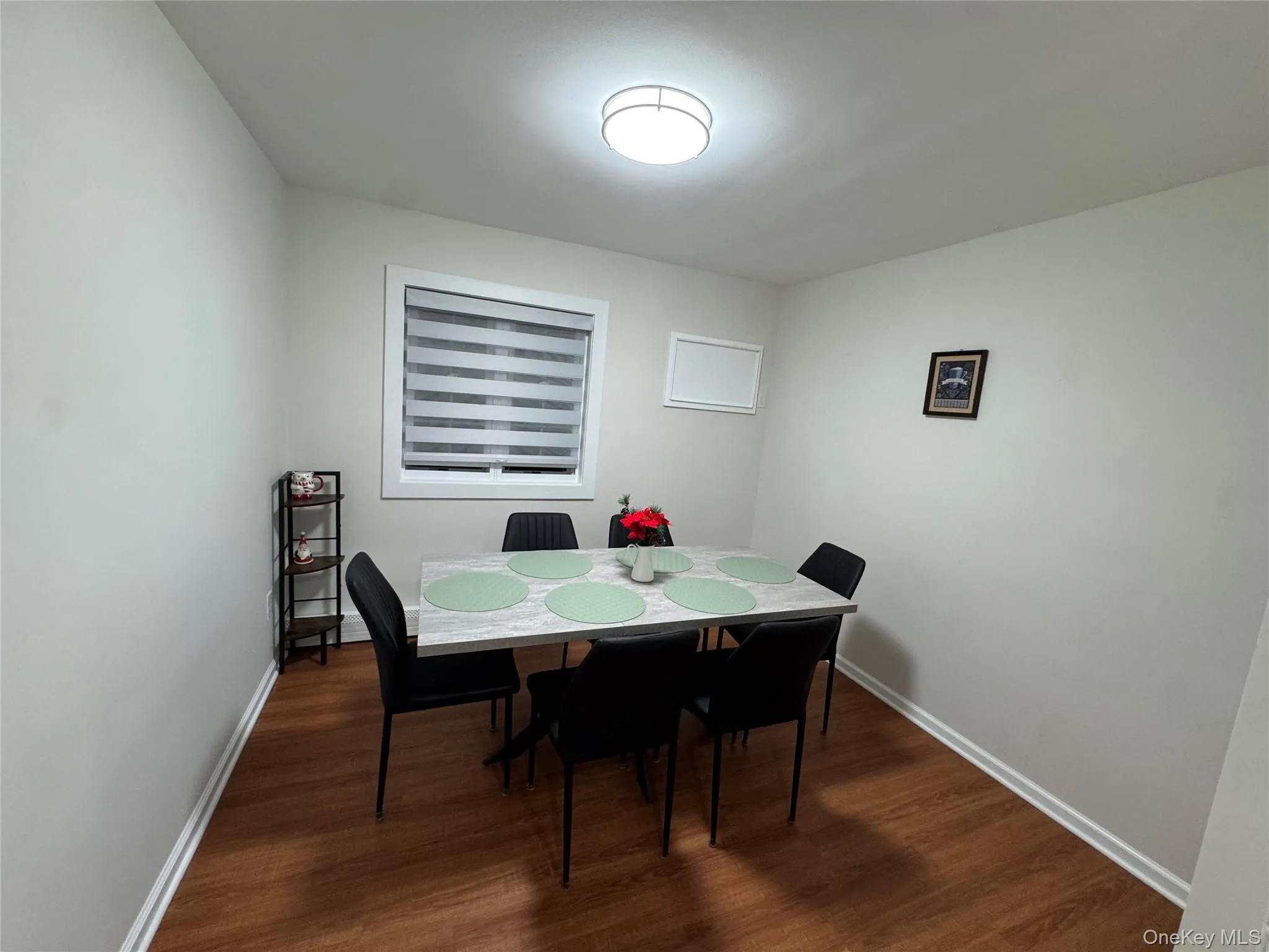 Dining area featuring dark wood-style flooring Dining area featuring dark wood-style flooring