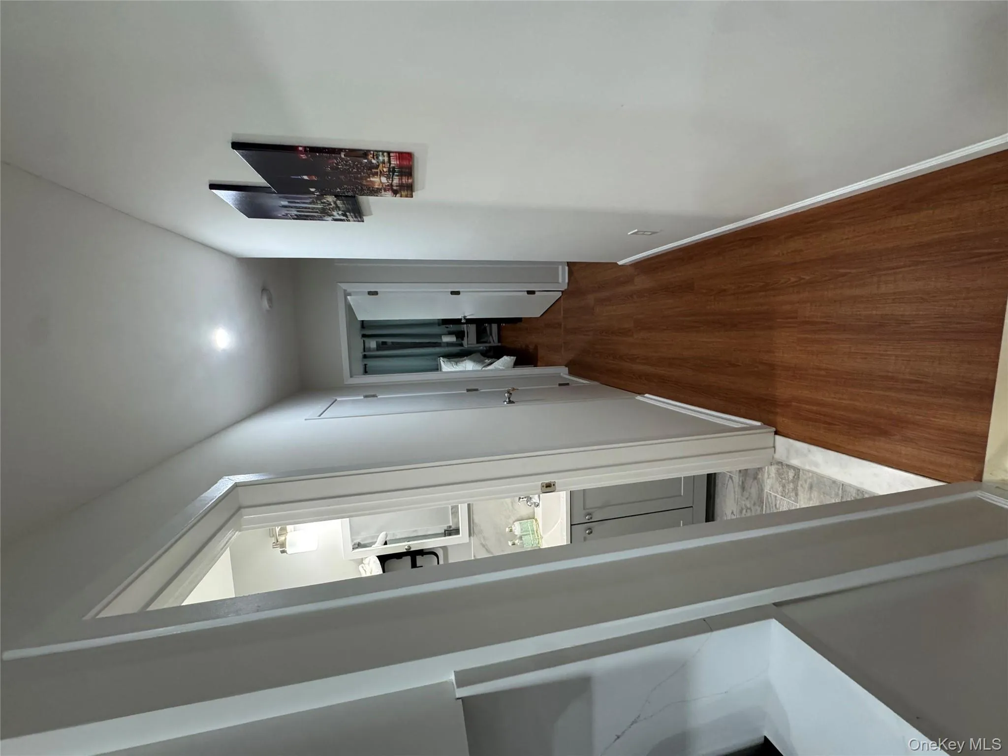 Hall featuring baseboards and light wood-style floors Hall featuring baseboards and light wood-style floors