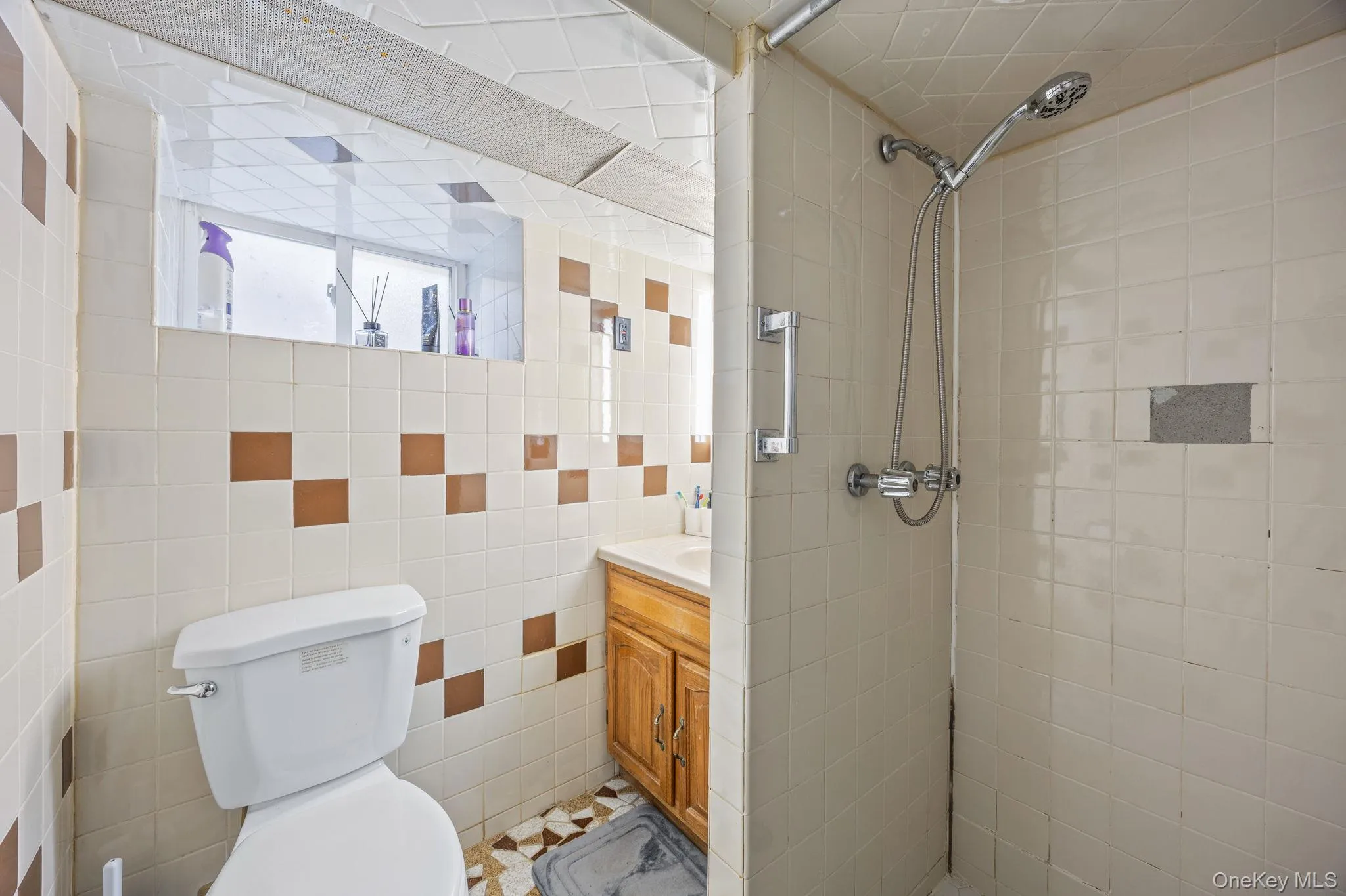 Bathroom featuring vanity and tiled shower Bathroom featuring vanity and tiled shower