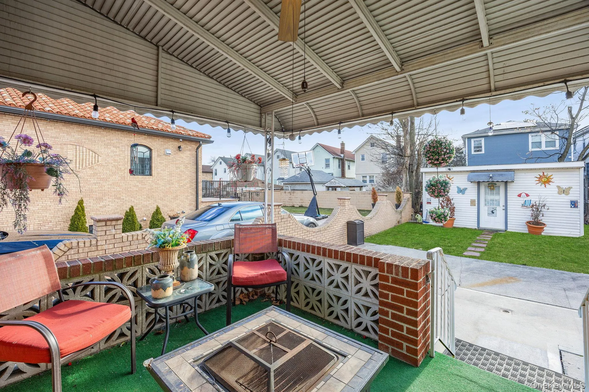 View of patio / terrace featuring an outdoor fire pit and a residential view View of patio / terrace featuring an outdoor fire pit and a residential view