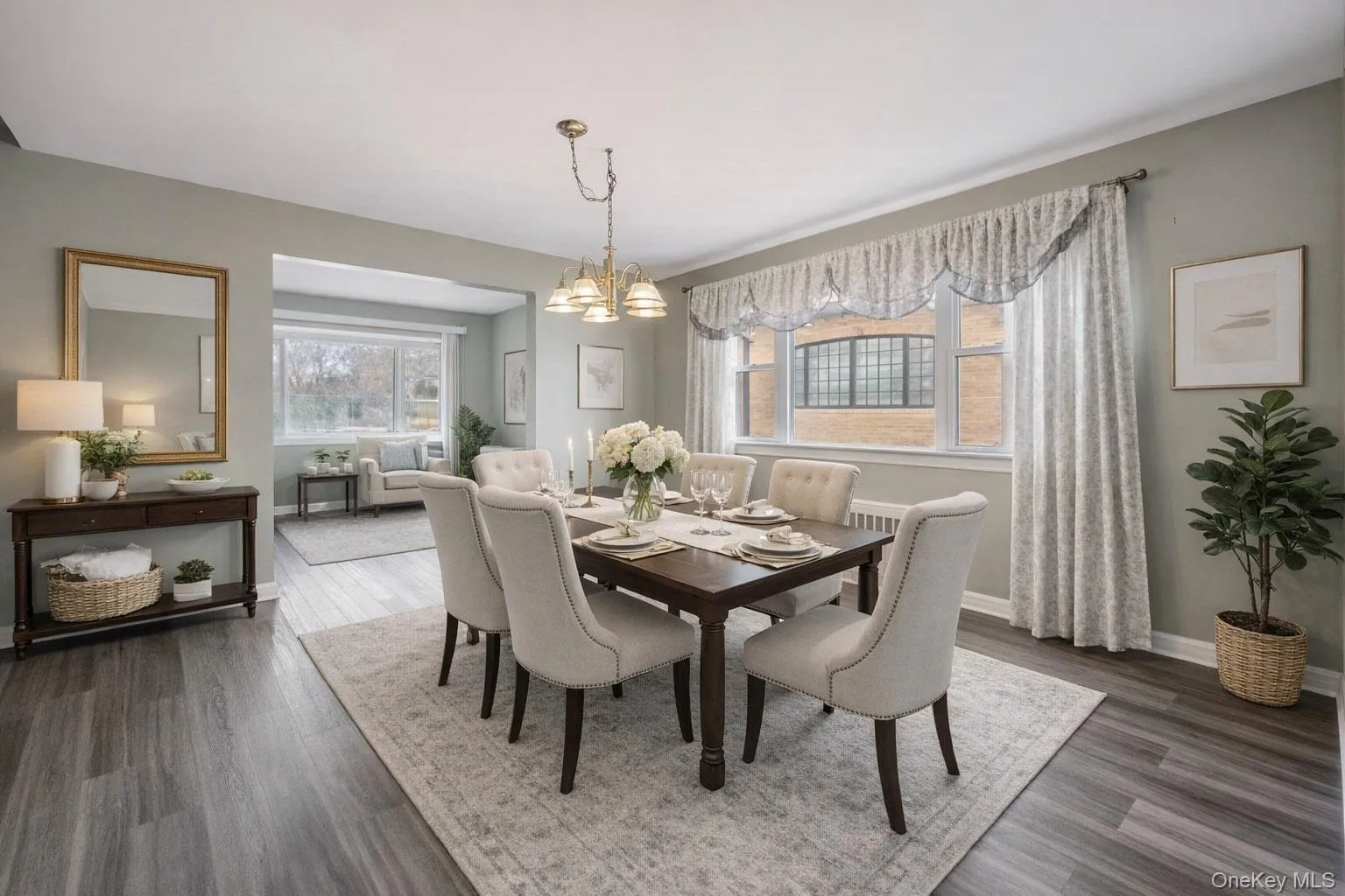 Dining room featuring a chandelier, dark wood-style floors, and plenty of natural light Dining room featuring a chandelier, dark wood-style floors, and plenty of natural light