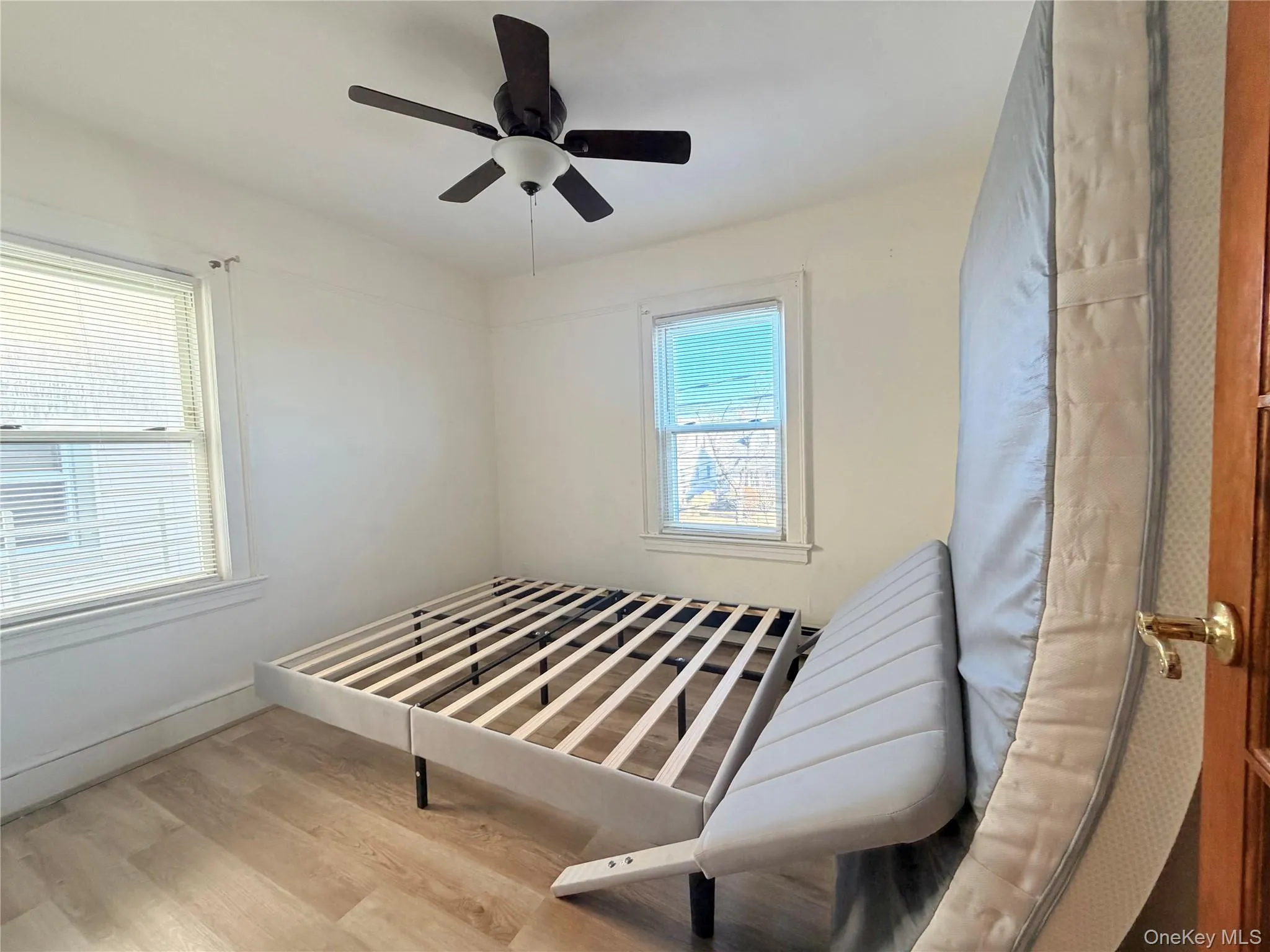 Bedroom with wood finished floors and ceiling fan Bedroom with wood finished floors and ceiling fan