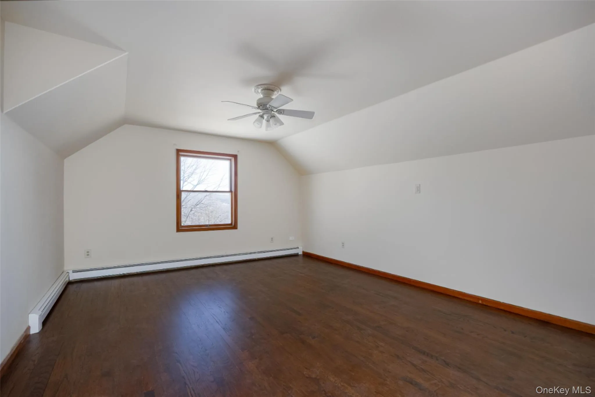 Bedroom 2 featuring lofted ceiling, walk-in-closet, ceiling fan, and wood floors Bedroom 2 featuring lofted ceiling, walk-in-closet, ceiling fan, and wood floors