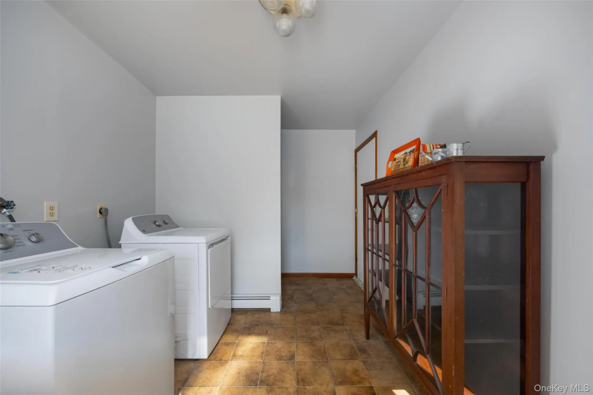 Laundry room featuring new washer and dryer and ceramic floors Laundry room featuring new washer and dryer and ceramic floors
