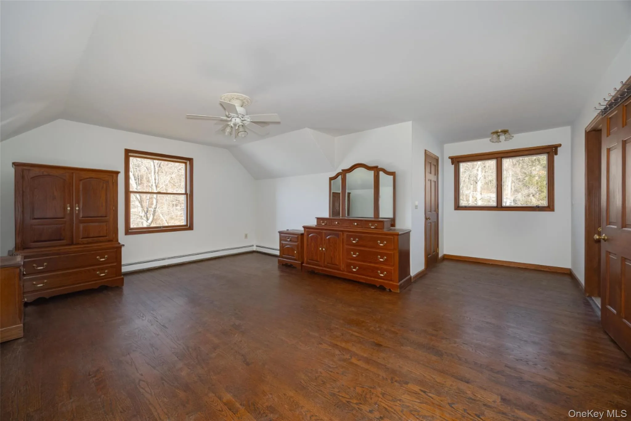 Bedroom 3 with vaulted ceiling, wood floors, a ceiling fan, and walk-in-closet Bedroom 3 with vaulted ceiling, wood floors, a ceiling fan, and walk-in-closet