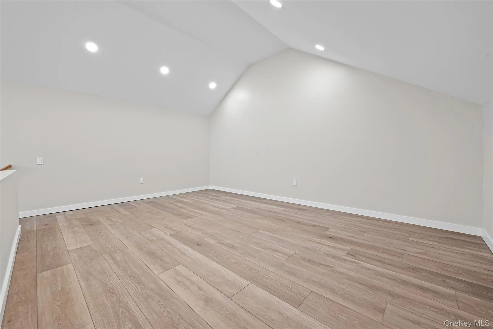 Bonus room featuring recessed lighting, light wood-style floors, and lofted ceiling Bonus room featuring recessed lighting, light wood-style floors, and lofted ceiling