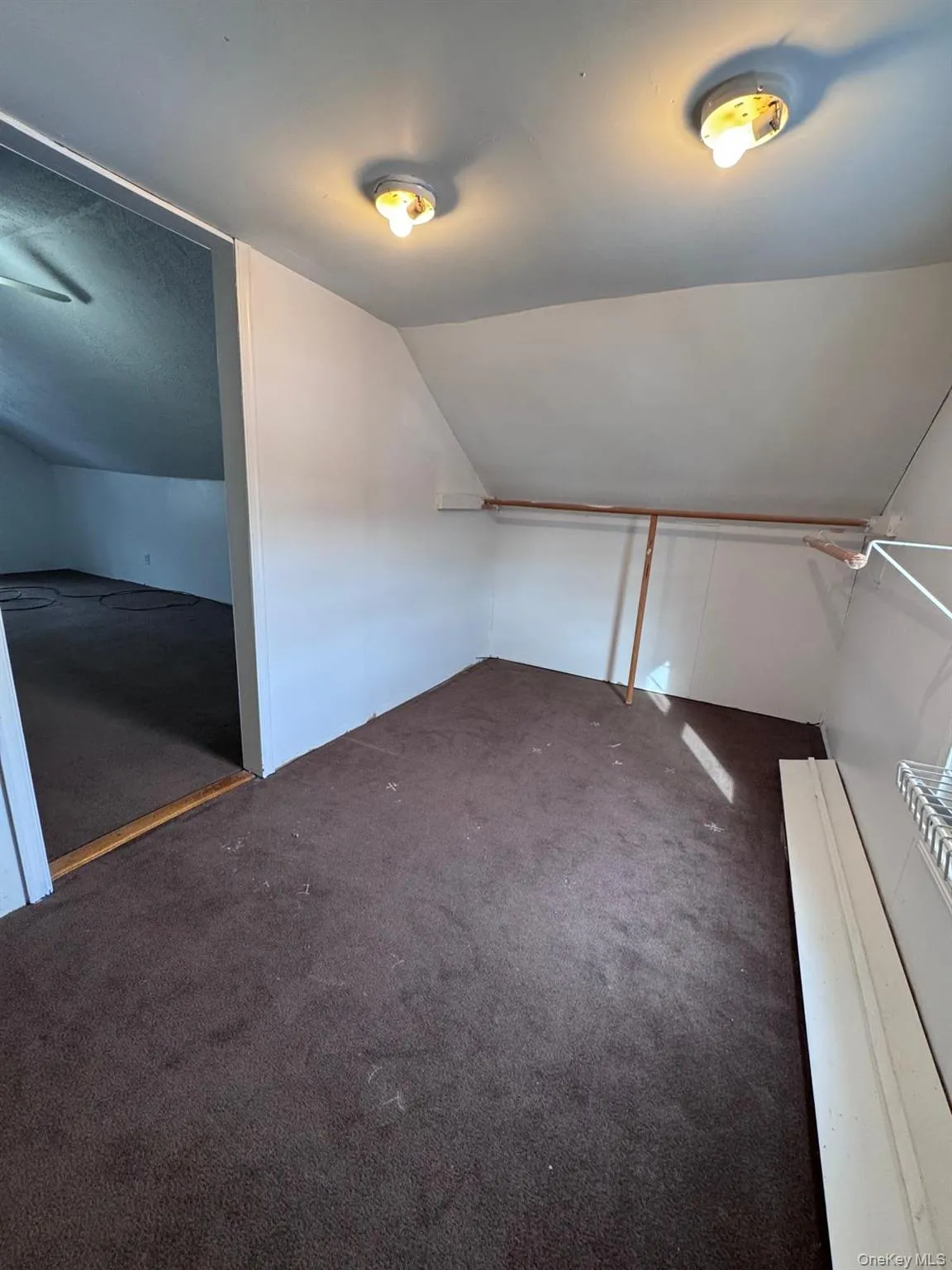 Bonus room with lofted ceiling and dark carpet Bonus room with lofted ceiling and dark carpet