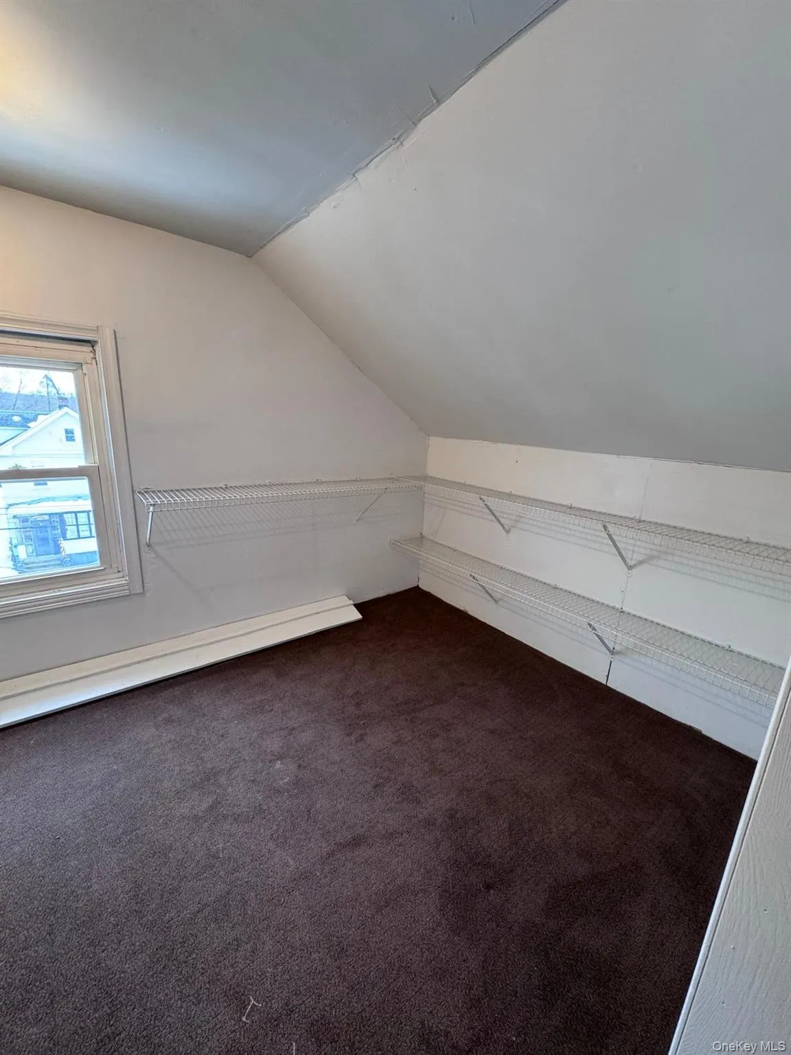 Additional living space featuring vaulted ceiling and carpet flooring Additional living space featuring vaulted ceiling and carpet flooring