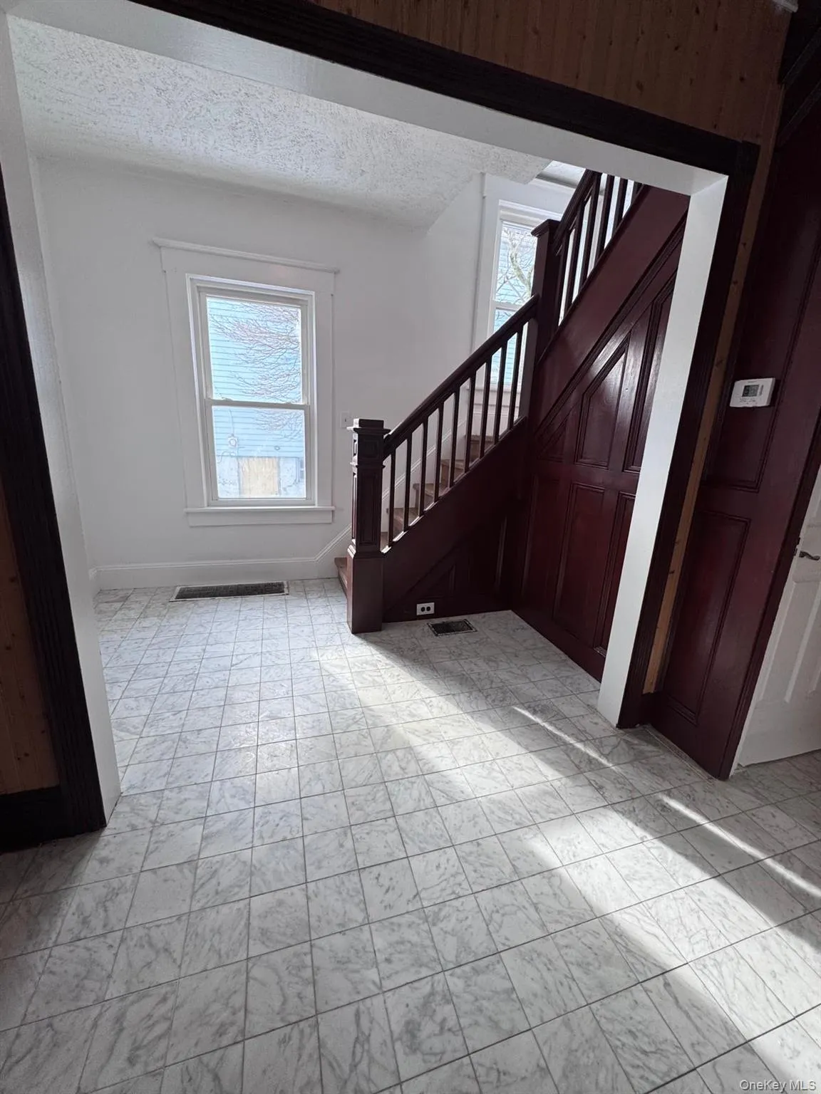Foyer entrance with stairs and a textured ceiling Foyer entrance with stairs and a textured ceiling