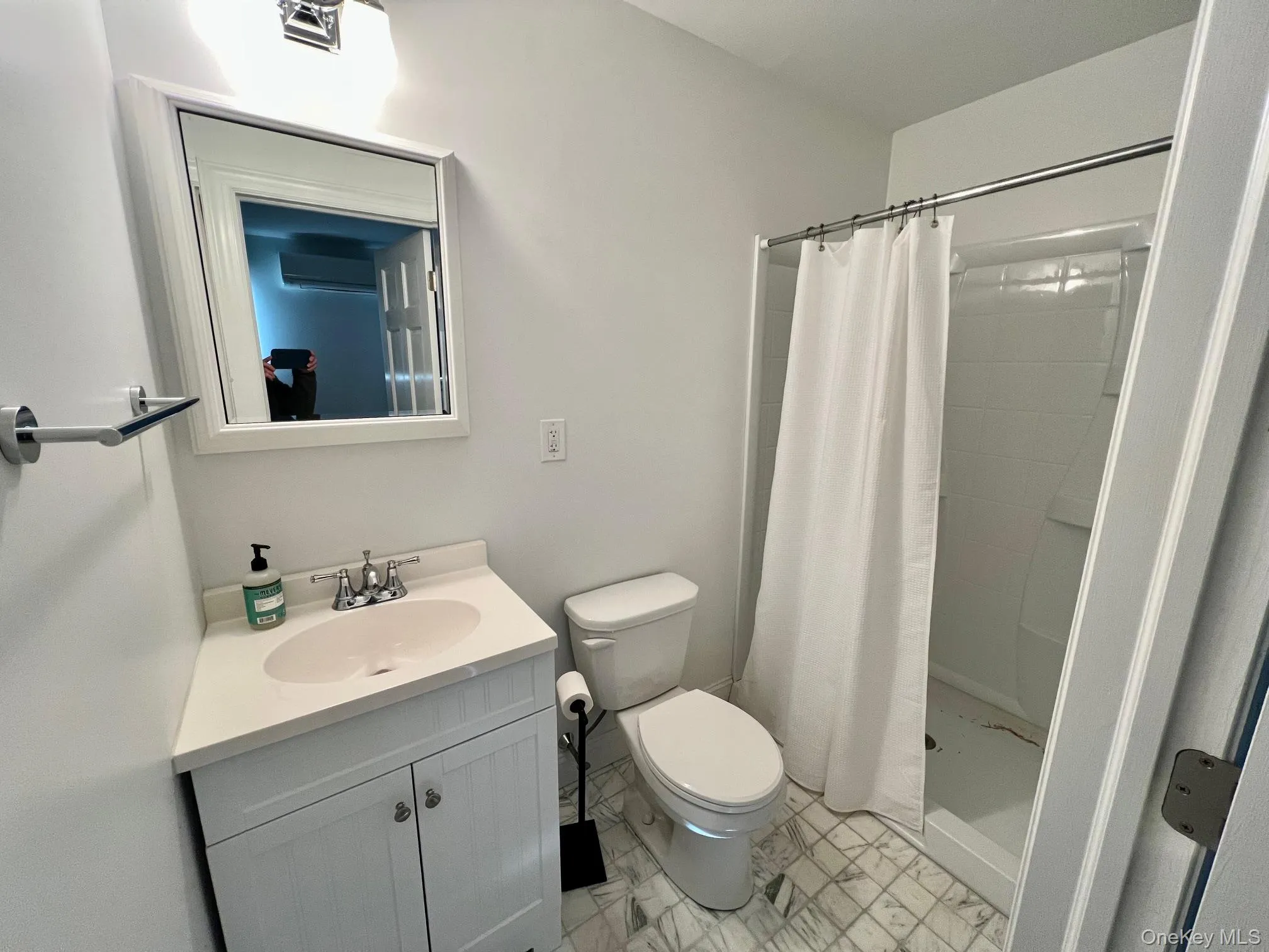 Full bathroom featuring a shower stall and vanity Full bathroom featuring a shower stall and vanity
