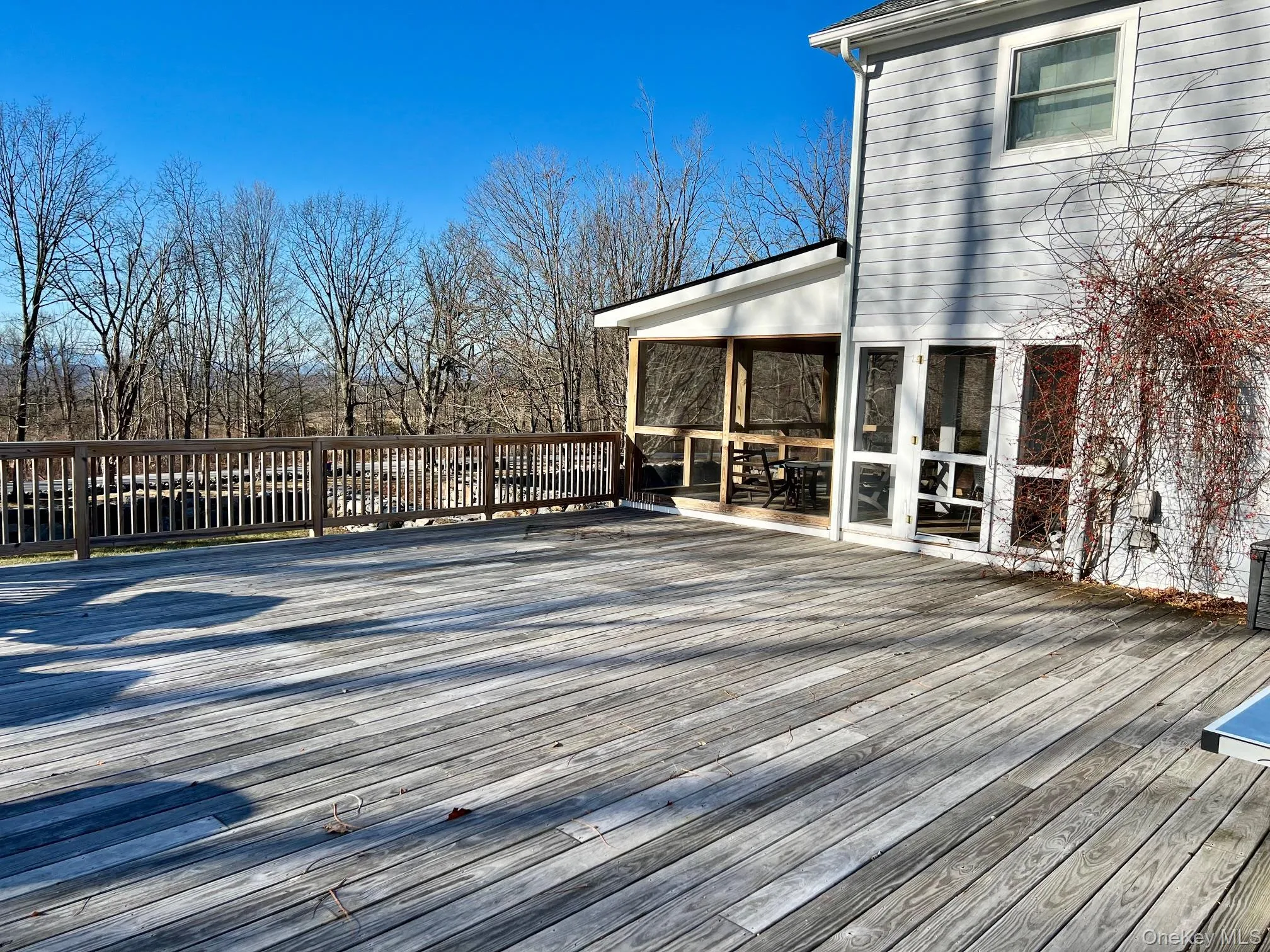 Wooden deck featuring door to screened porch Wooden deck featuring door to screened porch