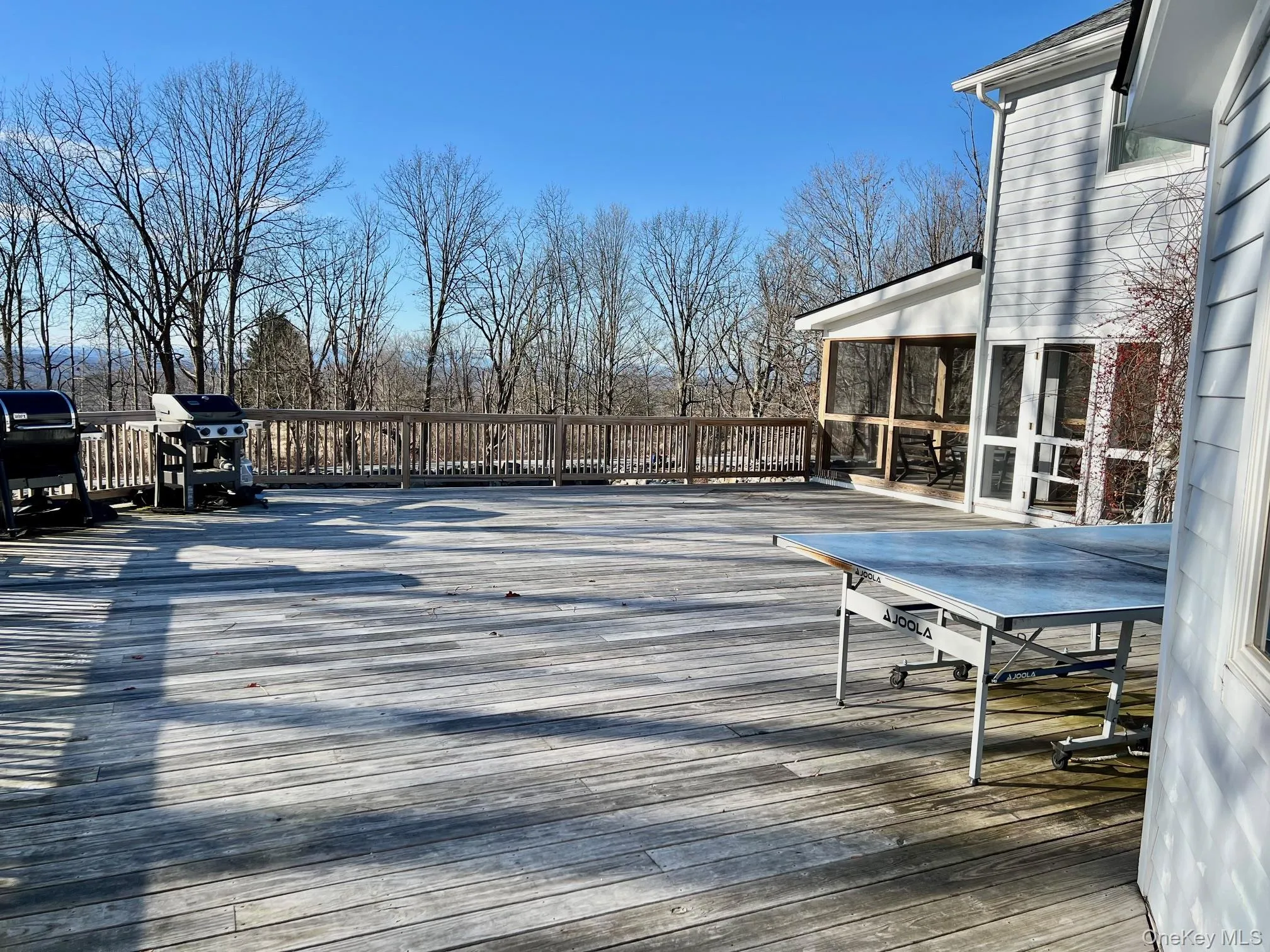 Wooden terrace featuring area for grilling, ping pong, and outdoor dining space Wooden terrace featuring area for grilling, ping pong, and outdoor dining space
