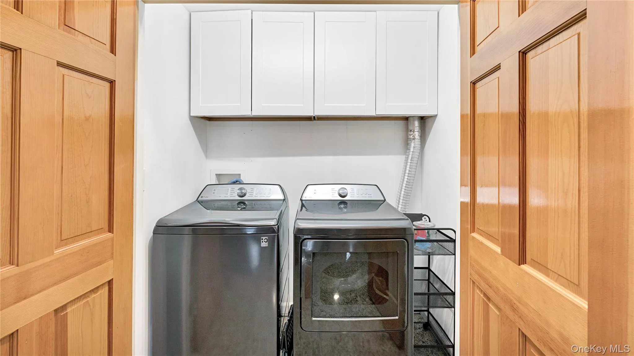 Laundry area with washer and clothes dryer and cabinet space Laundry area with washer and clothes dryer and cabinet space
