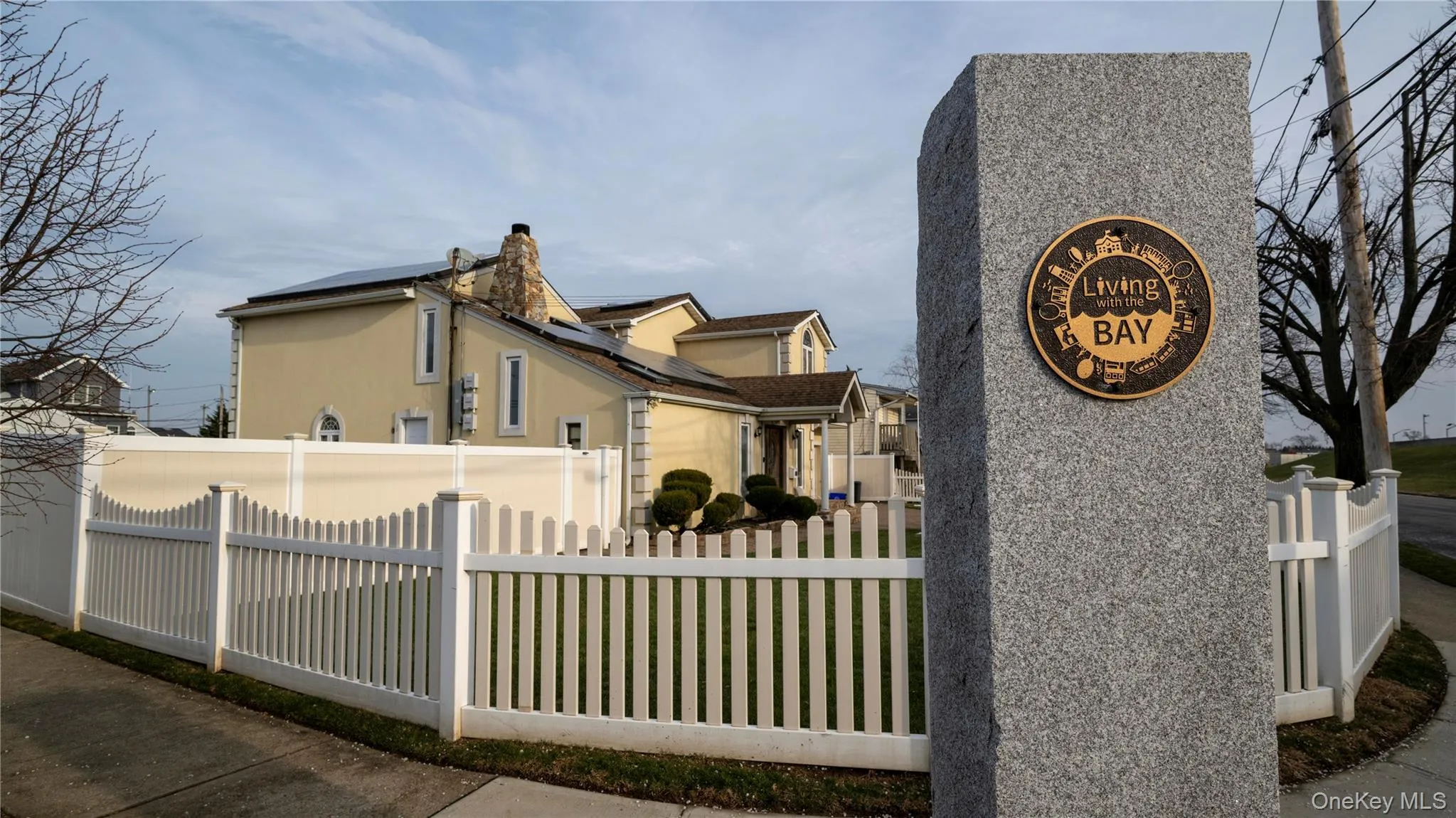 View of property exterior featuring a fenced front yard, stucco siding, and a chimney View of property exterior featuring a fenced front yard, stucco siding, and a chimney
