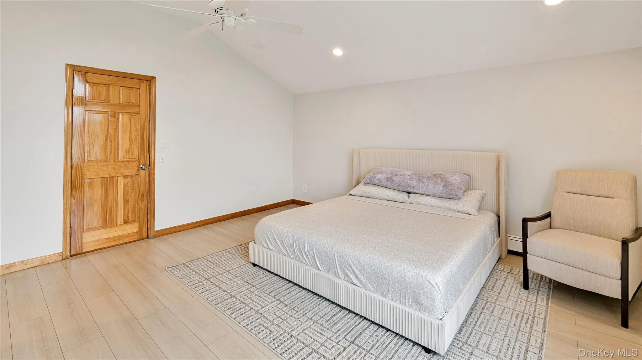 Bedroom featuring vaulted ceiling, light wood-style floors, a ceiling fan, and recessed lighting Bedroom featuring vaulted ceiling, light wood-style floors, a ceiling fan, and recessed lighting