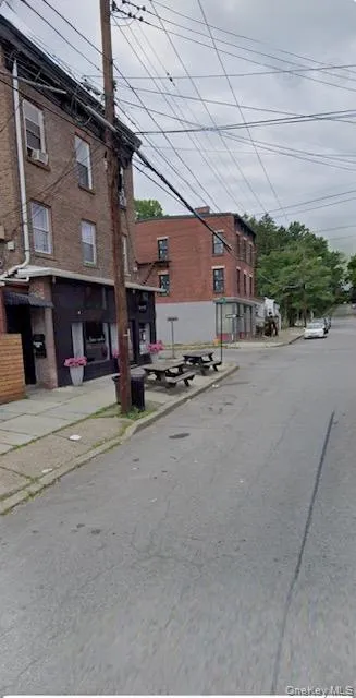 View of asphalt road featuring curbs and sidewalks View of asphalt road featuring curbs and sidewalks