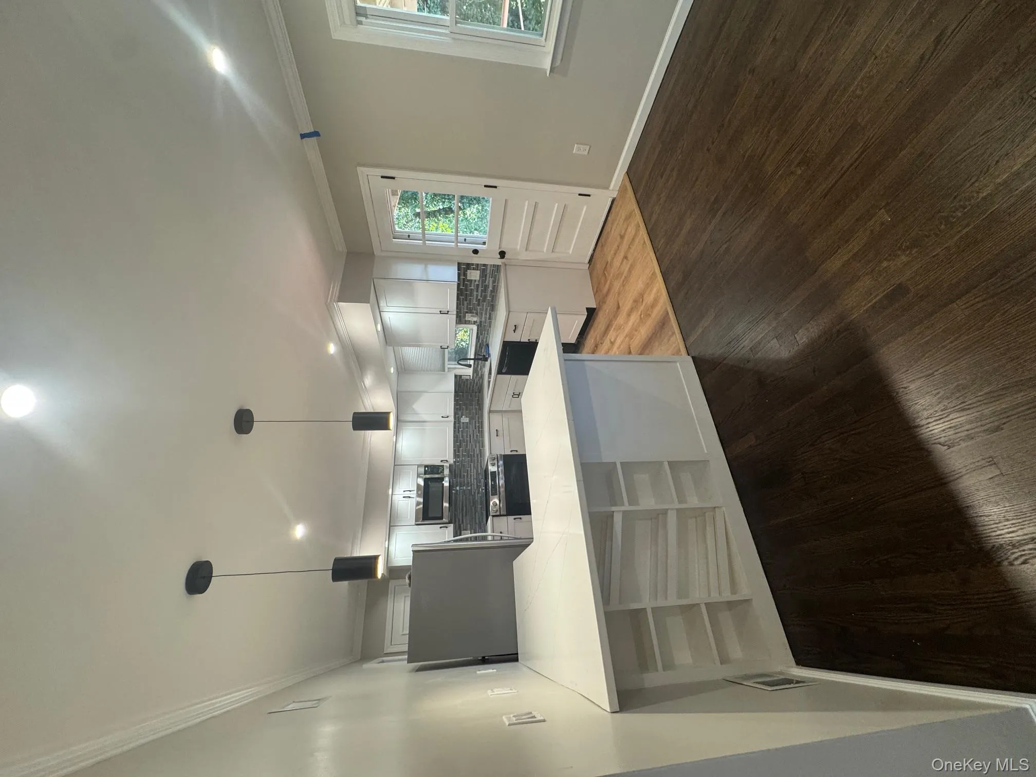 Kitchen with ornamental molding, white cabinets, recessed lighting, decorative light fixtures, and fridge Kitchen with ornamental molding, white cabinets, recessed lighting, decorative light fixtures, and fridge