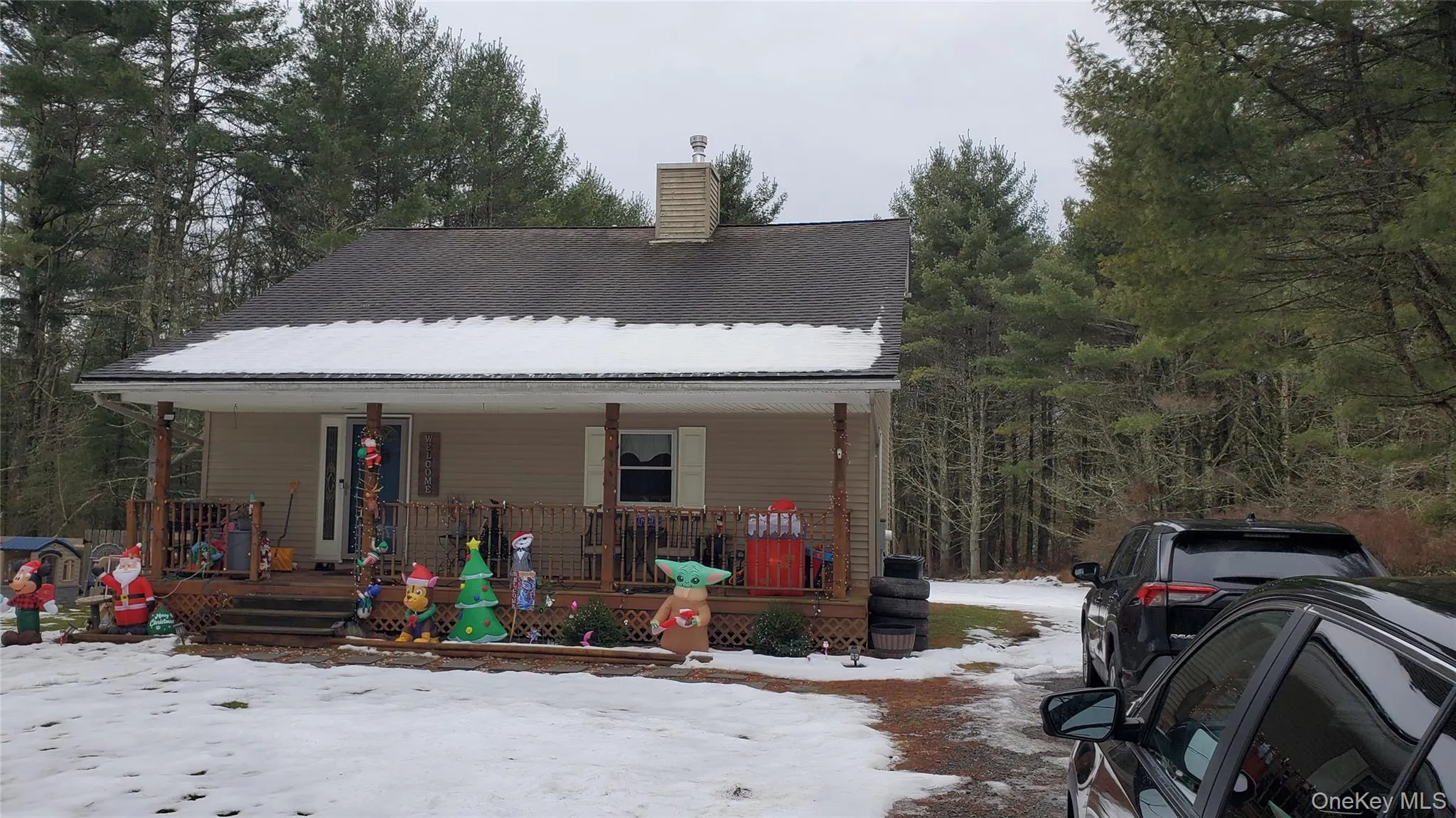 View of front of home with covered porch and a chimney View of front of home with covered porch and a chimney