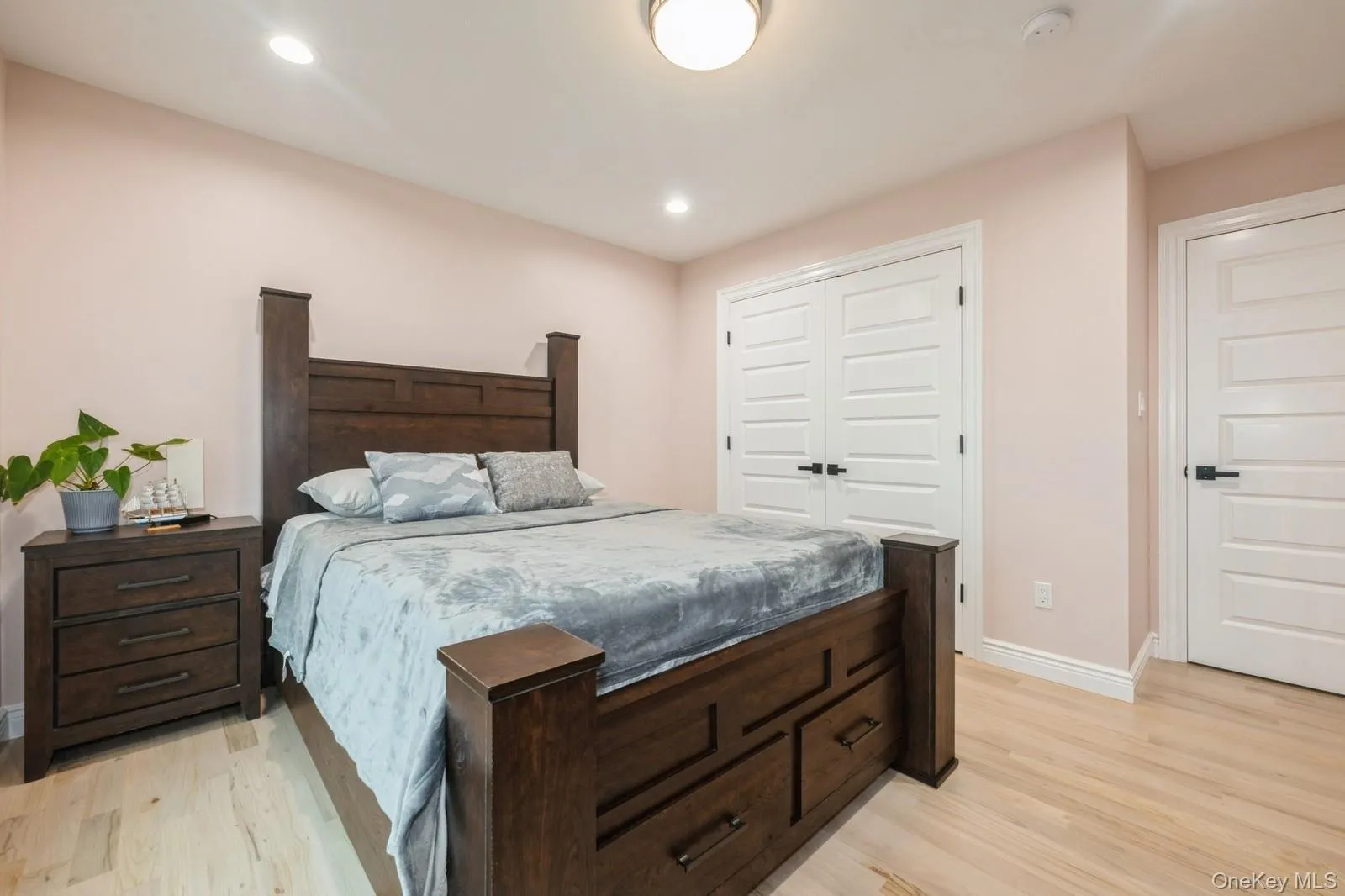 Bedroom with a closet, light wood finished floors, and recessed lighting Bedroom with a closet, light wood finished floors, and recessed lighting