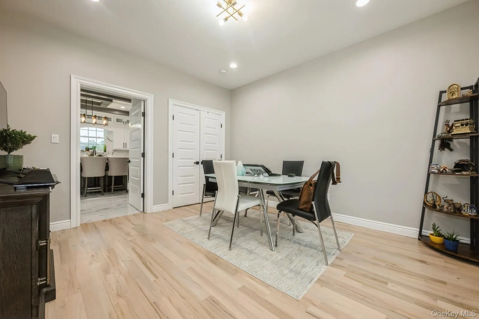 Dining room with light wood-style flooring, an office area, and recessed lighting Dining room with light wood-style flooring, an office area, and recessed lighting