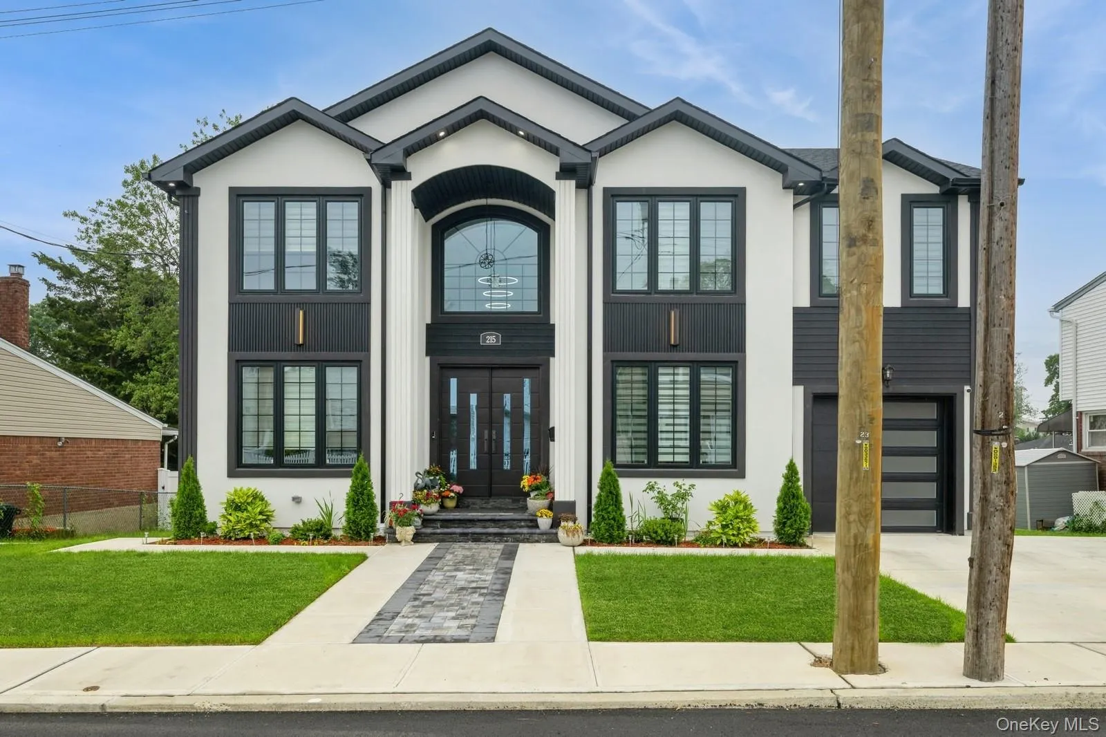 View of front of home featuring a front lawn, concrete driveway, stucco siding, and an attached garage View of front of home featuring a front lawn, concrete driveway, stucco siding, and an attached garage