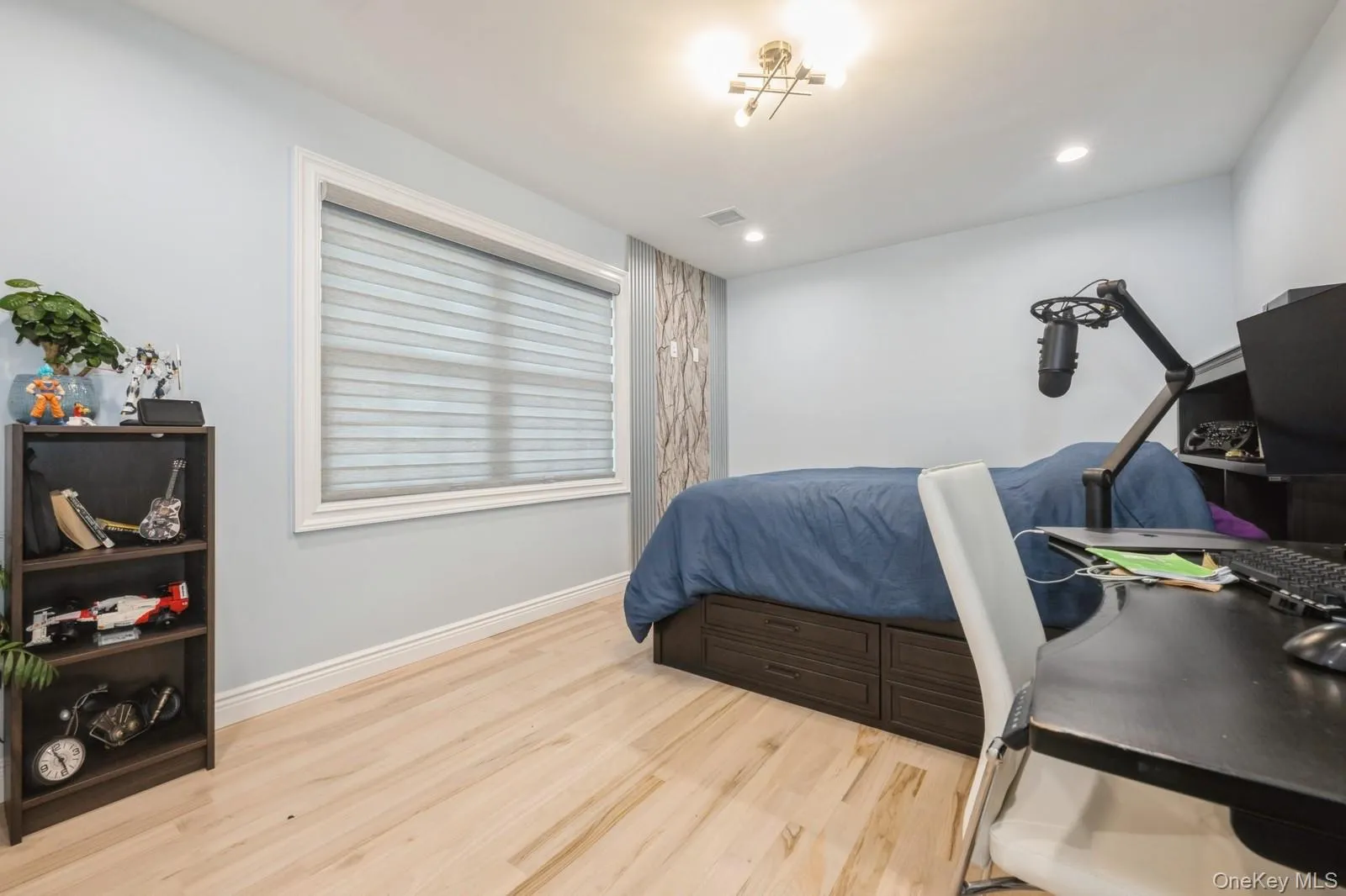 Bedroom with light wood finished floors and recessed lighting Bedroom with light wood finished floors and recessed lighting