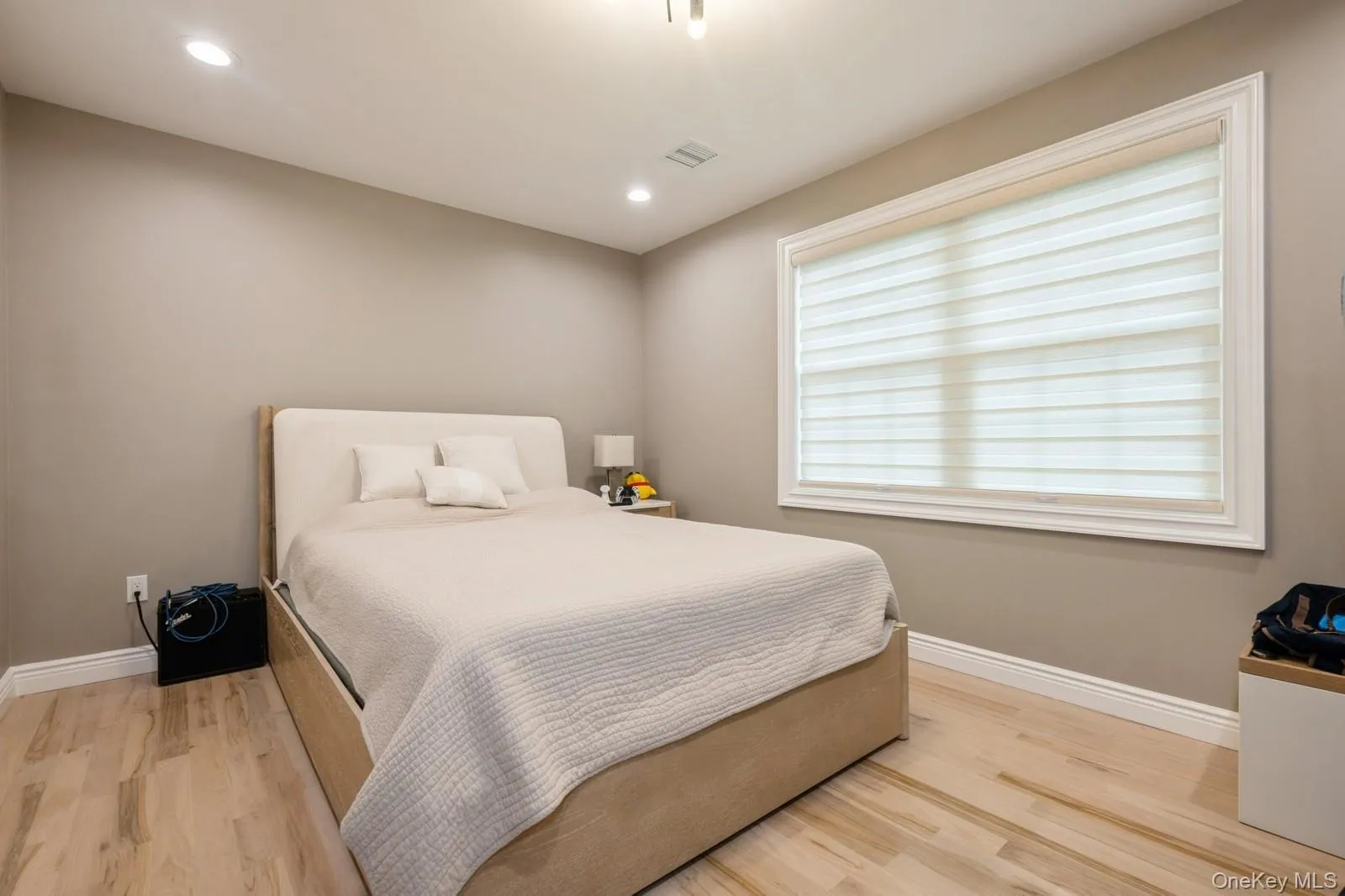 Bedroom featuring light wood-style flooring and recessed lighting Bedroom featuring light wood-style flooring and recessed lighting