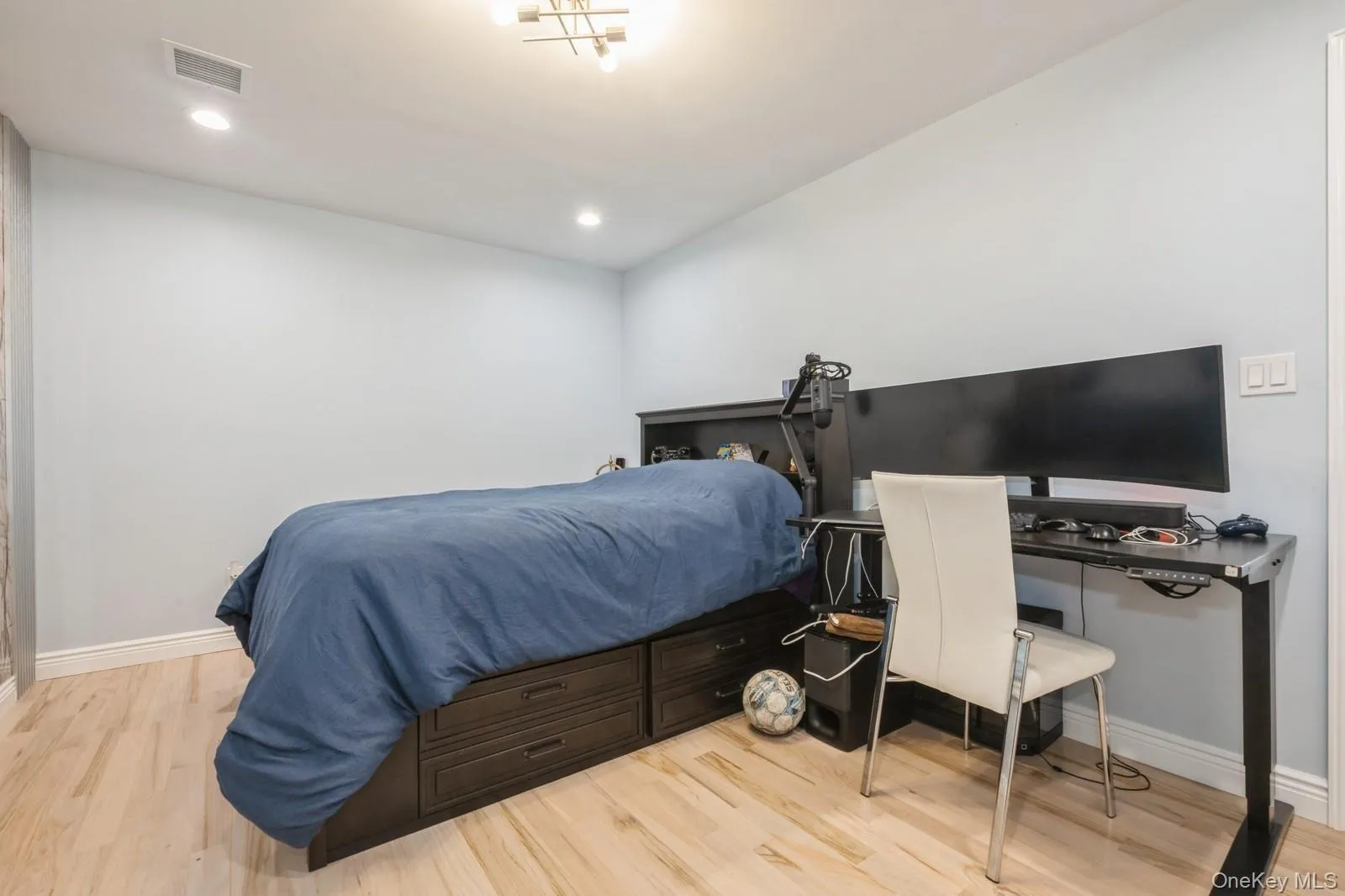 Bedroom with light wood-style floors, a desk, and recessed lighting Bedroom with light wood-style floors, a desk, and recessed lighting
