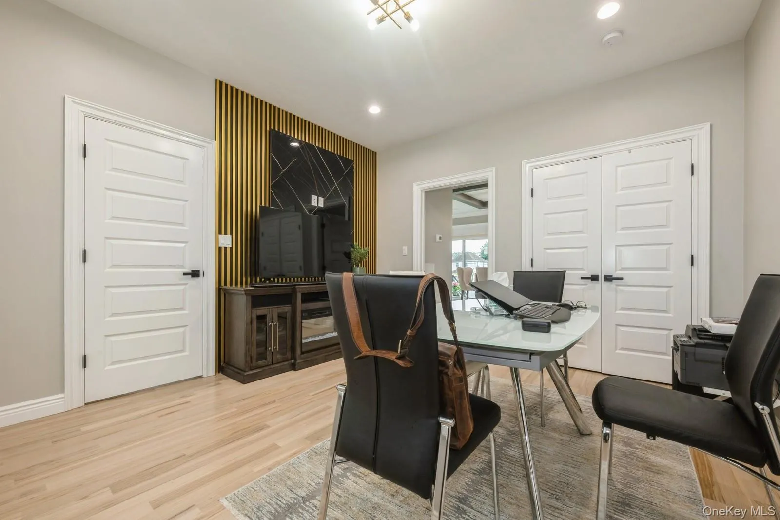Home office with light wood-type flooring and recessed lighting Home office with light wood-type flooring and recessed lighting