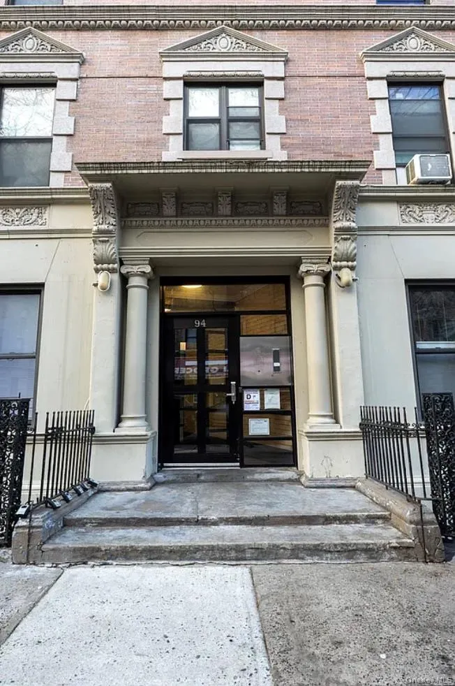 Property entrance with brick siding and cooling unit Property entrance with brick siding and cooling unit