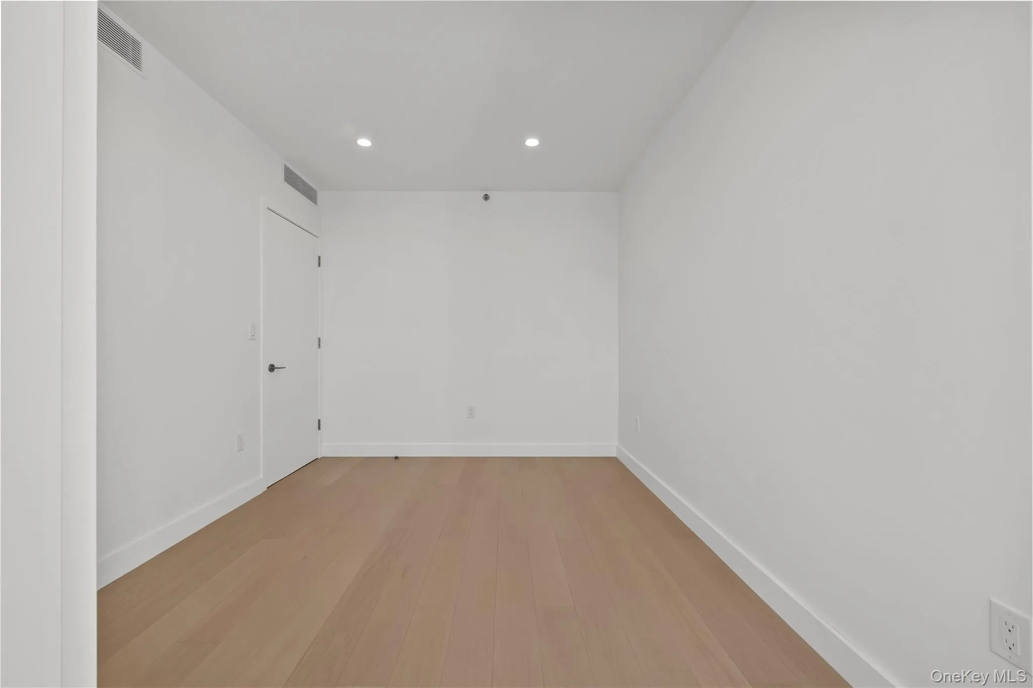 Empty room with recessed lighting and light wood finished floors Empty room with recessed lighting and light wood finished floors