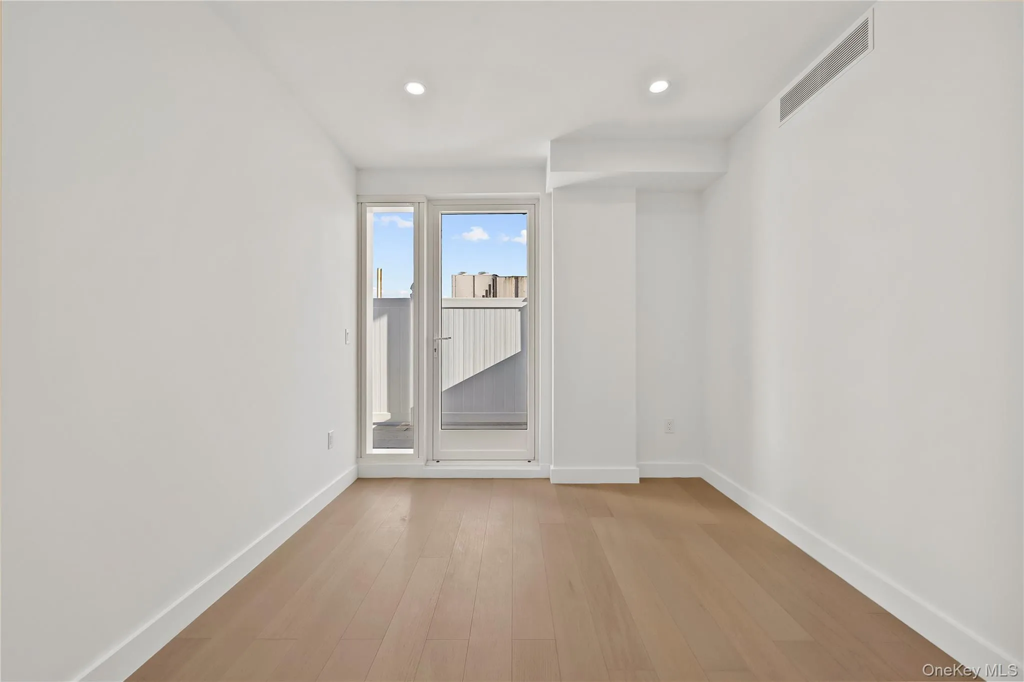 Spare room with light wood-style floors and recessed lighting Spare room with light wood-style floors and recessed lighting