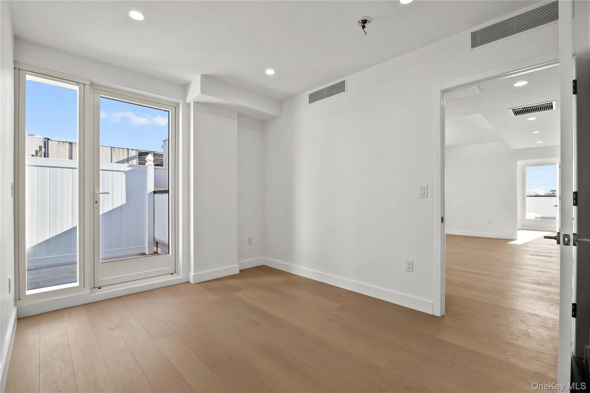 Spare room featuring healthy amount of natural light, light wood-style floors, and recessed lighting Spare room featuring healthy amount of natural light, light wood-style floors, and recessed lighting