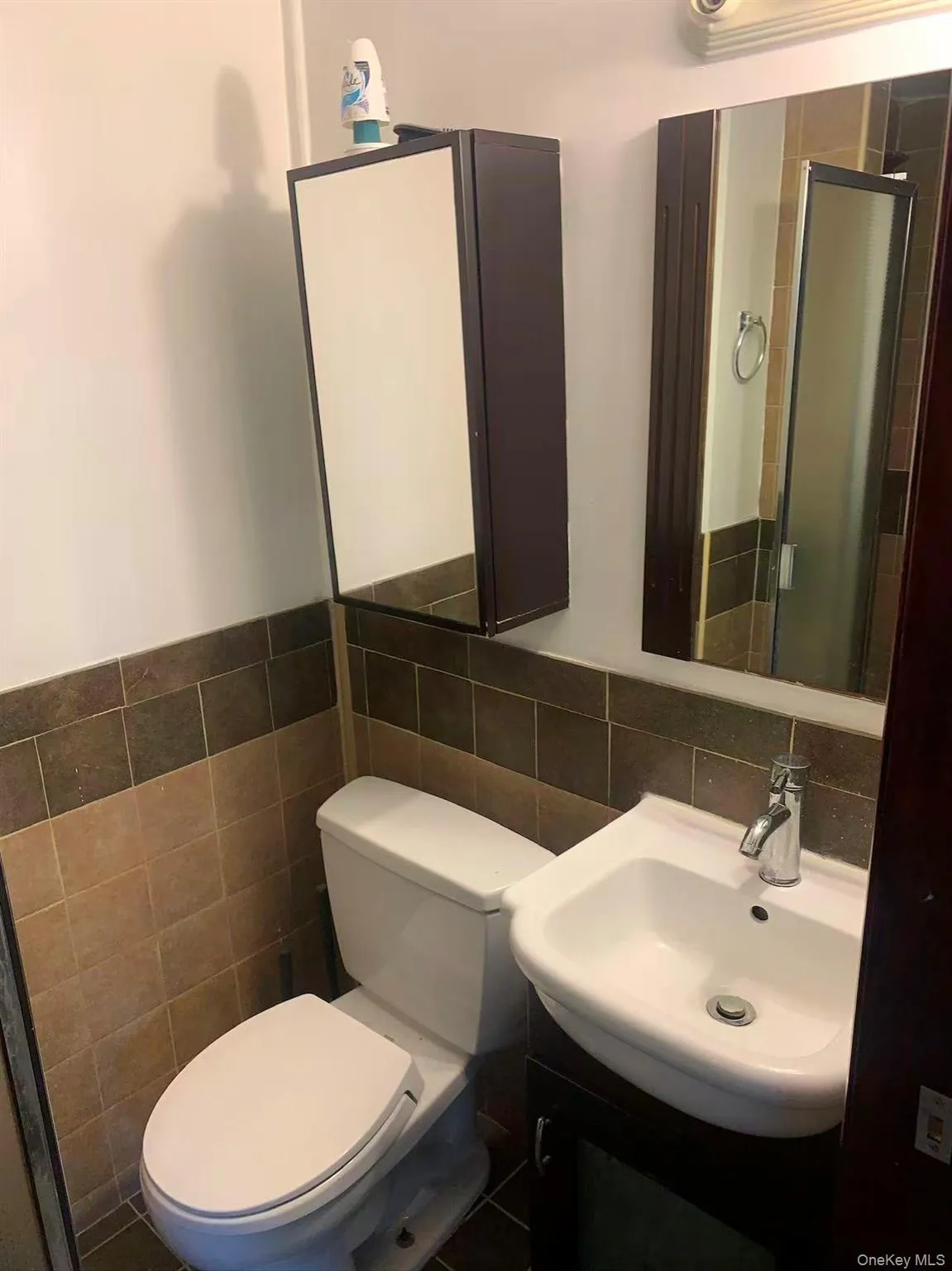 Full bath featuring vanity, a shower stall, and tile walls Full bath featuring vanity, a shower stall, and tile walls
